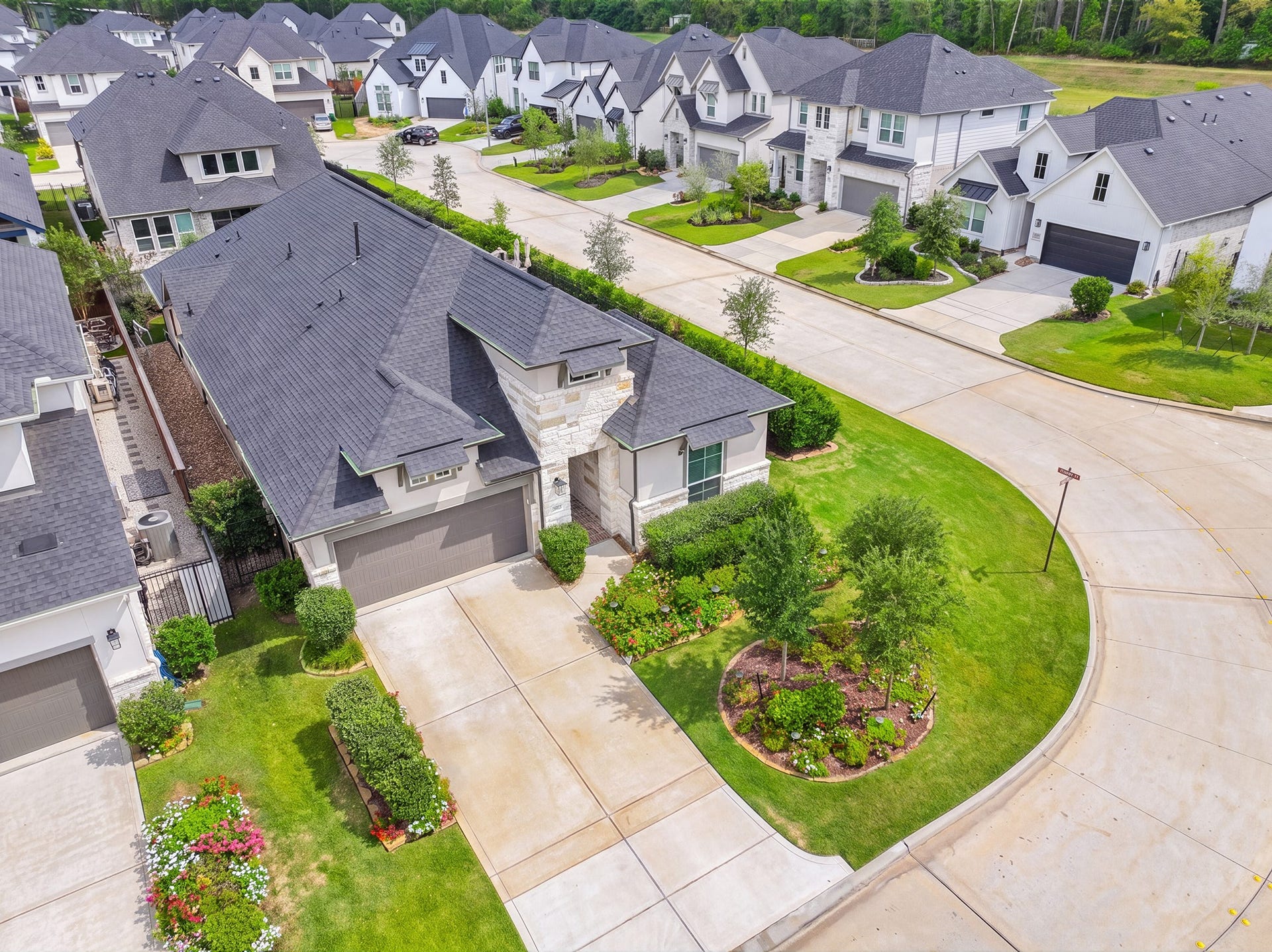 The home's corner setting gives it extra street frontage and curb presence, with mature trees, green space and a gently curving street that keeps through traffic to a minimum.