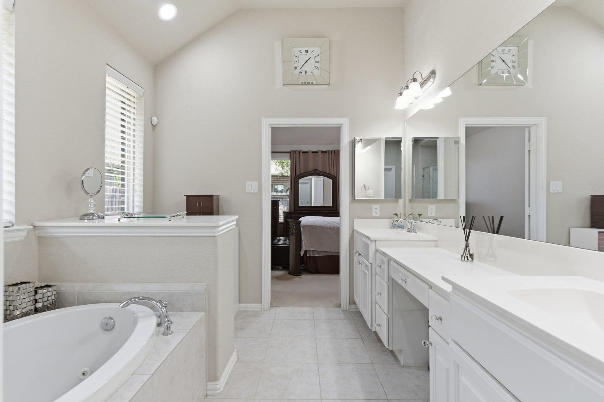 View from your closet shows your large private bath with dual vanities with ample space for everything you need.