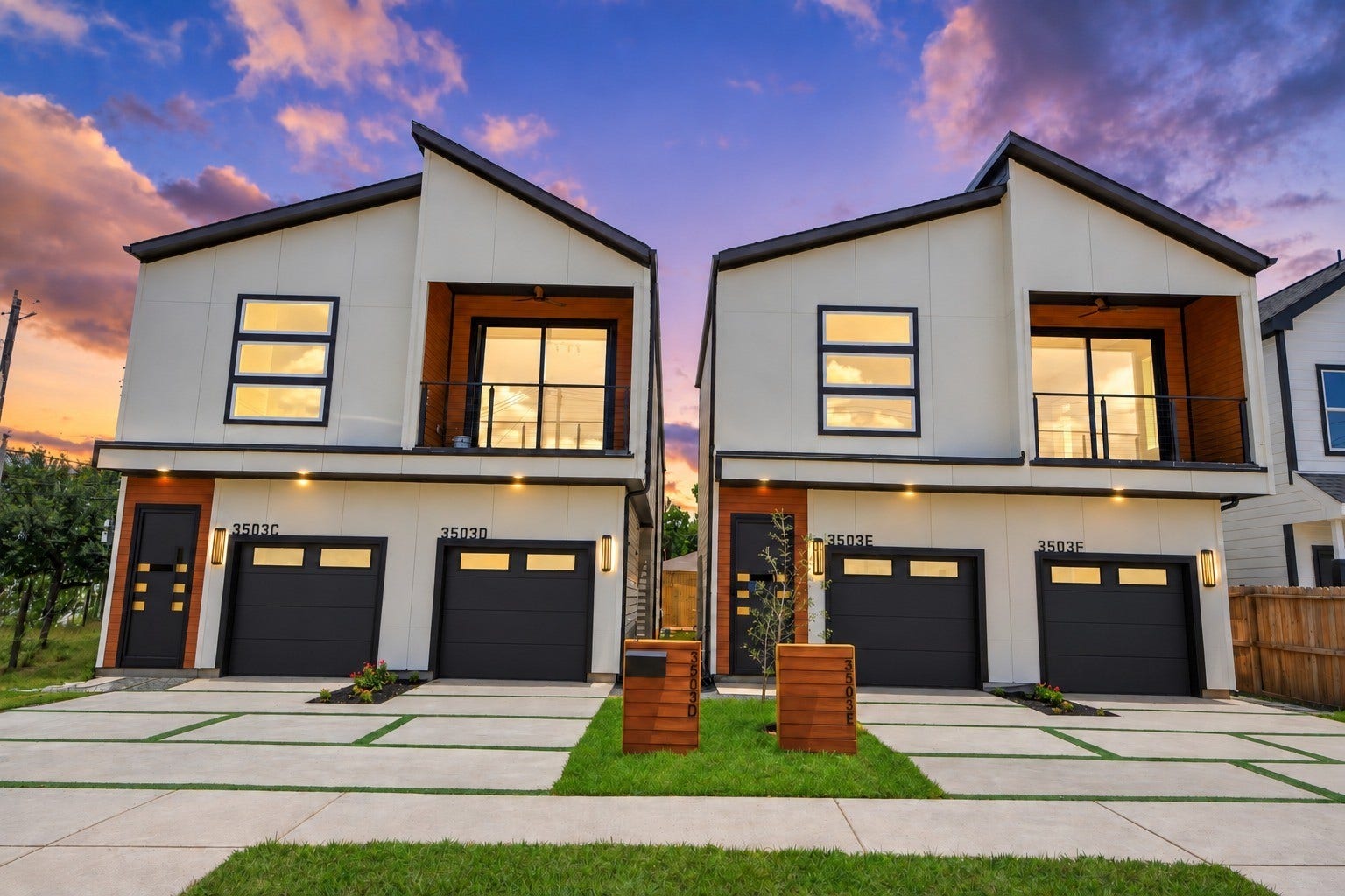 A striking twilight introduction showcasing the modern architecture and commanding curb appeal of Units C and D.