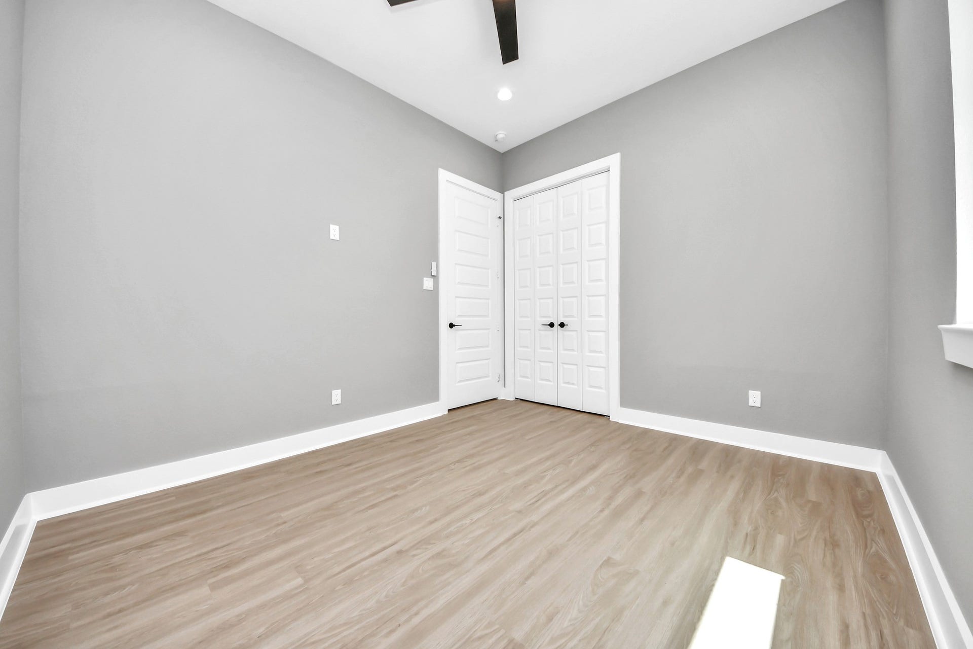 A bright secondary bedroom offering comfortable proportions, modern flooring and flexible furnishing options.