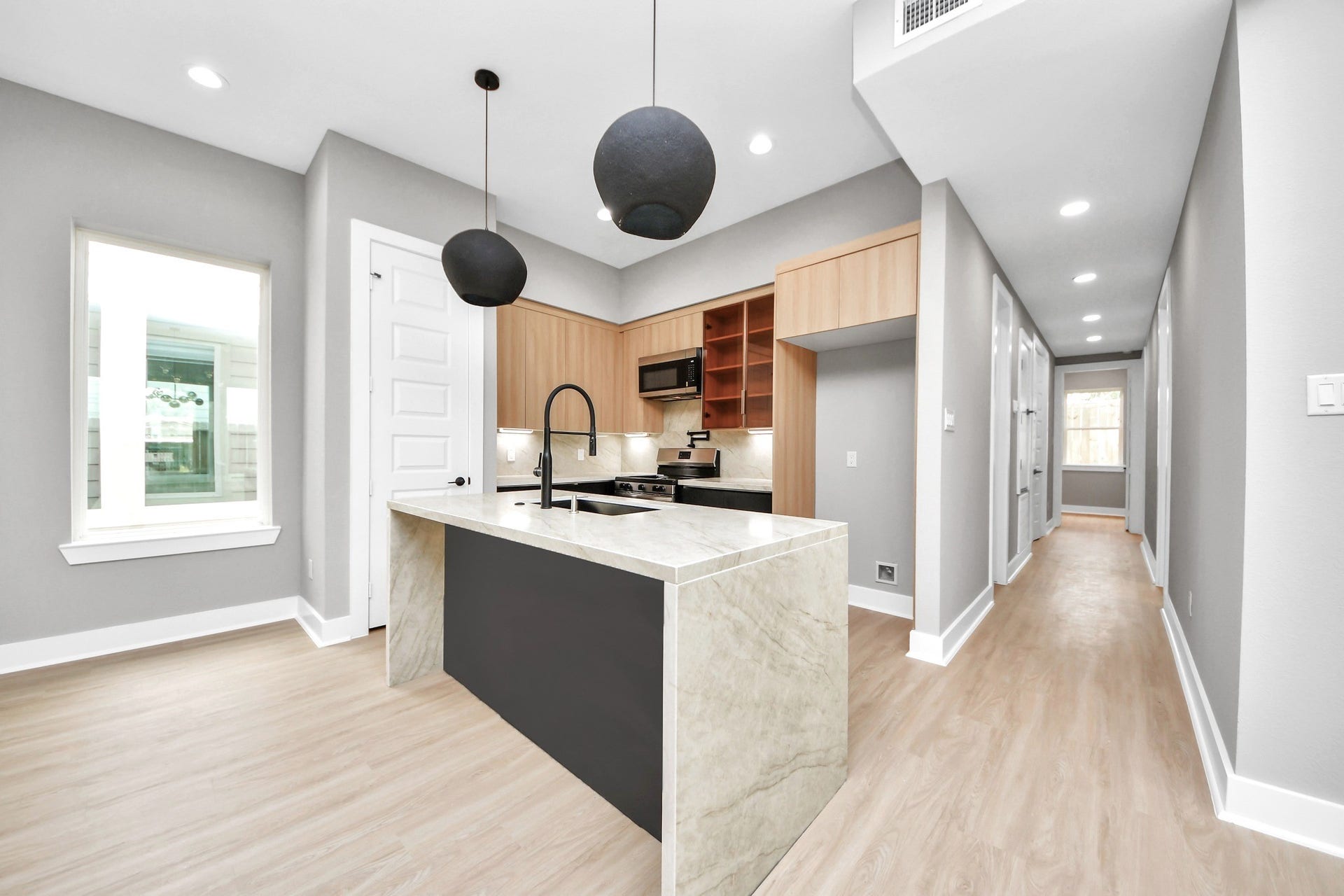 Unit Ds kitchen overlooks the main living spaces, making daily living and entertaining feel effortless.