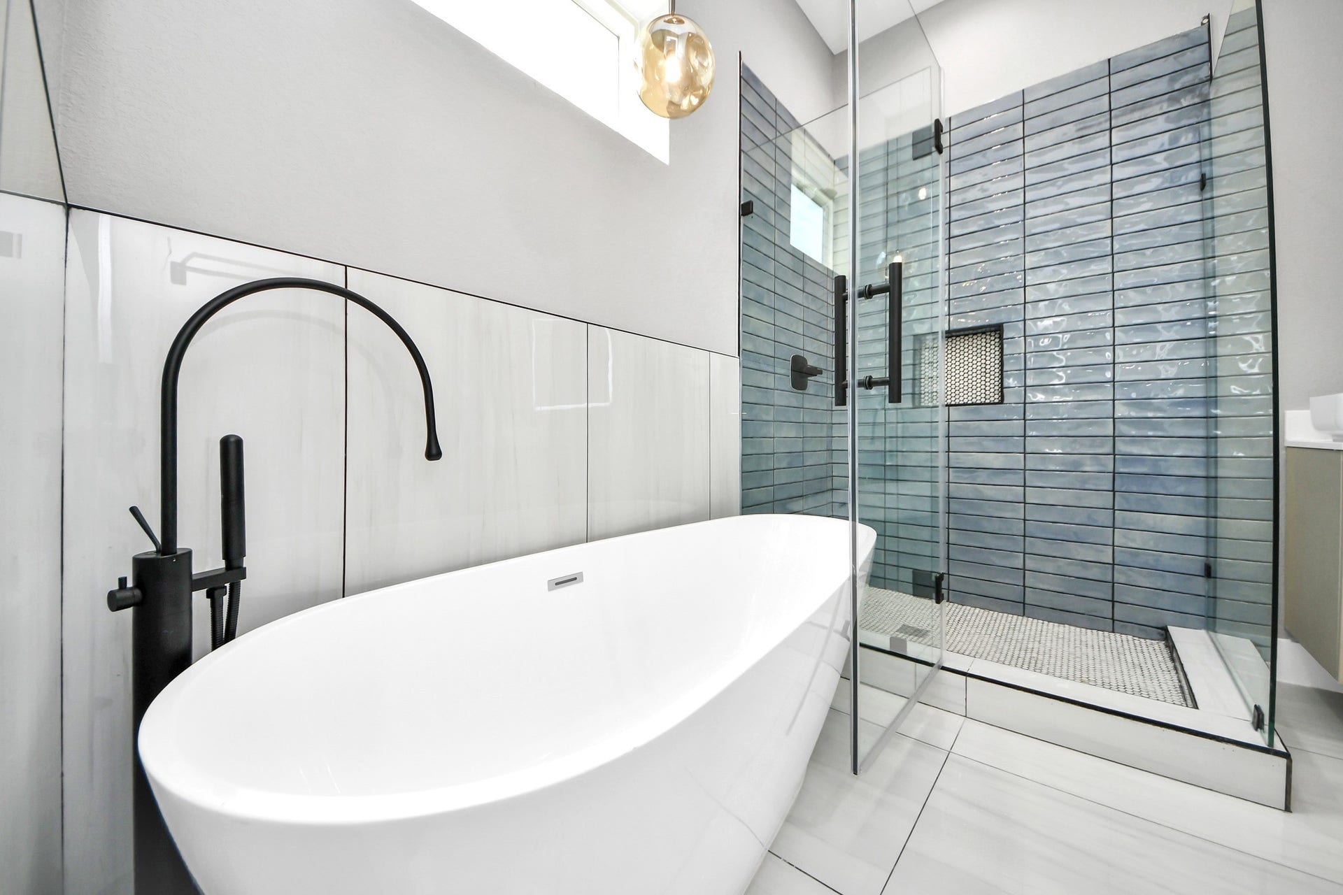 Unwind in the freestanding soaking tub or refresh in the oversized glass-enclosed shower.