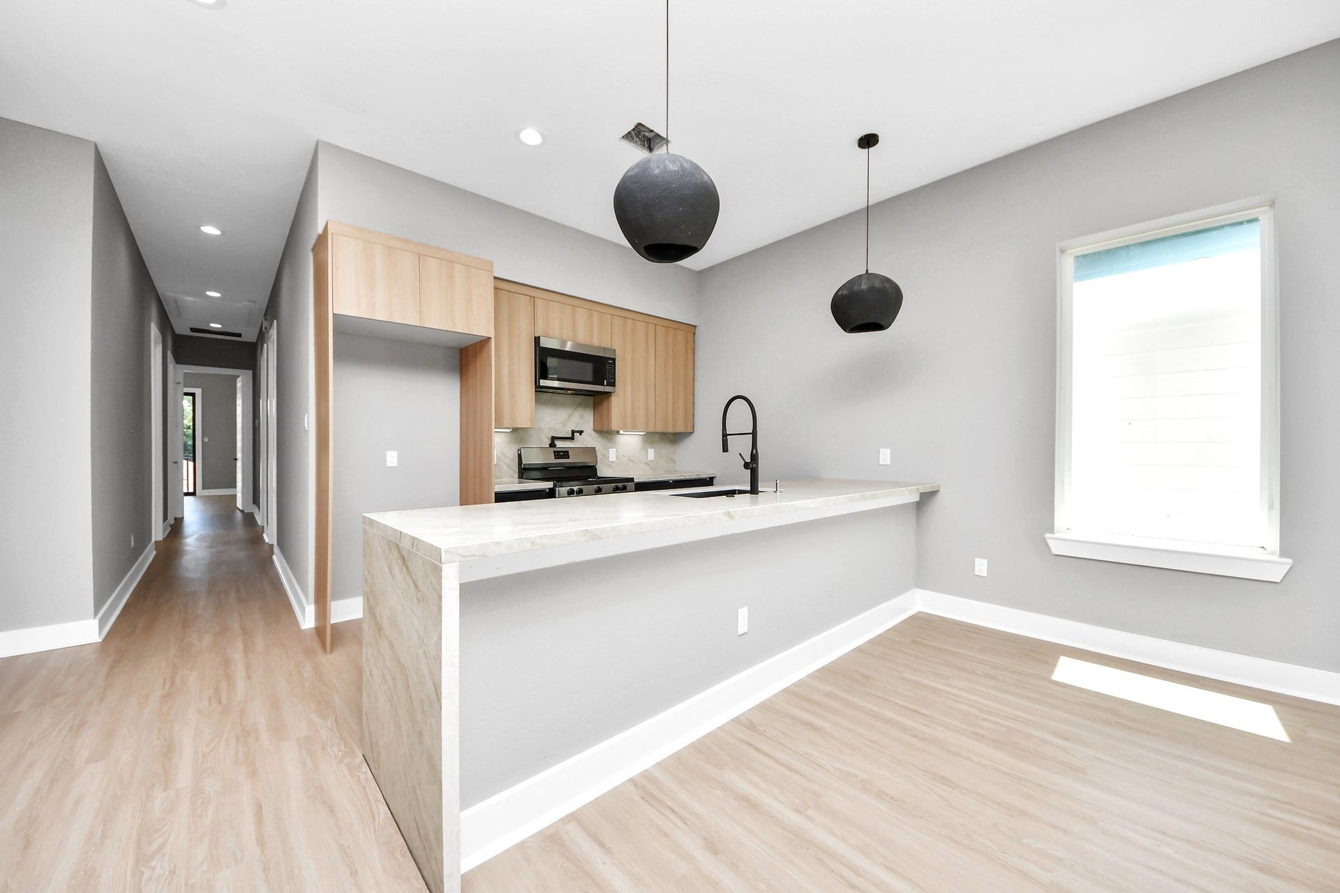 The open kitchen keeps everyone connected with the living and dining areas while providing excellent everyday function.