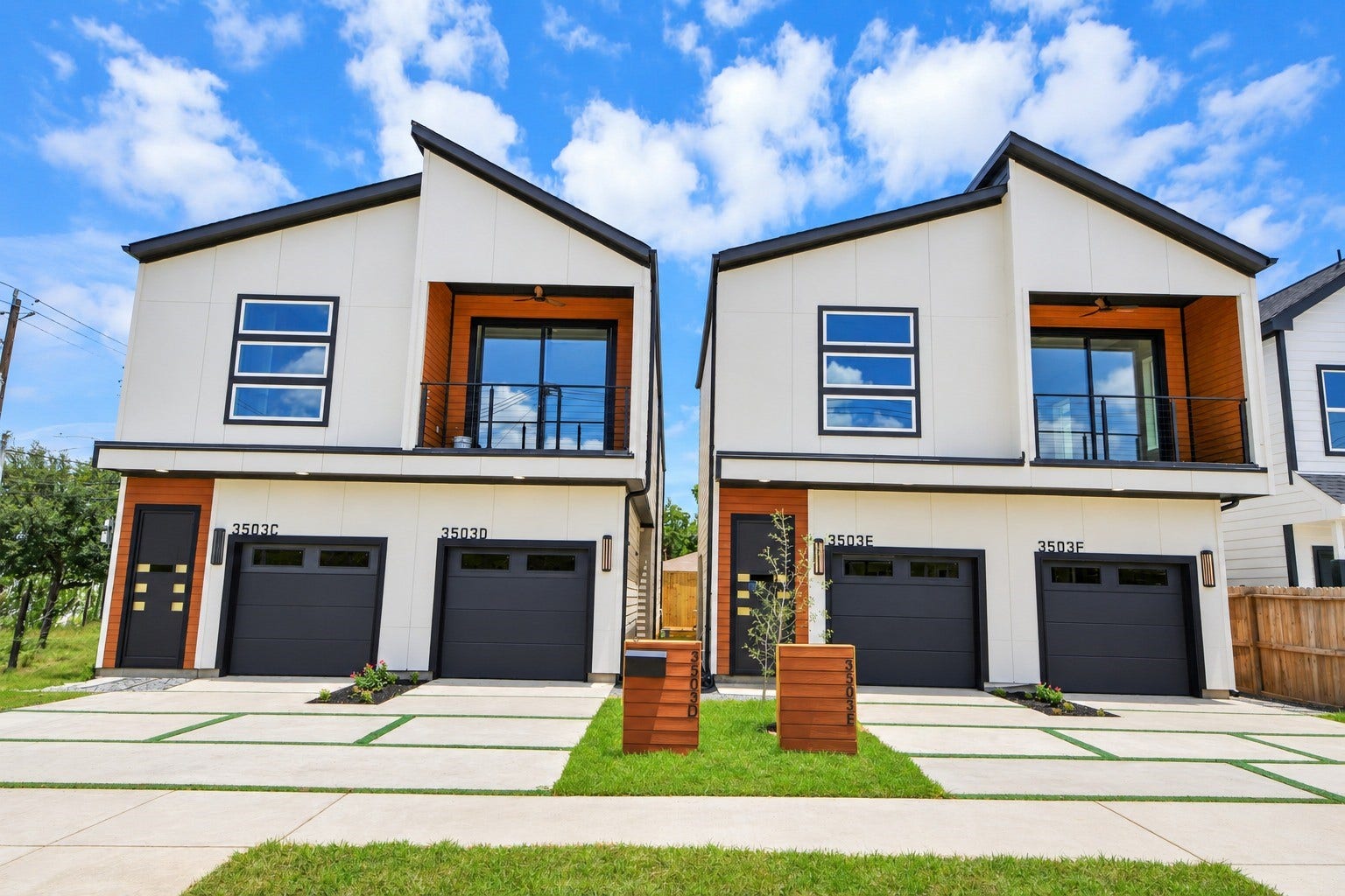 Clean lines, warm wood accents and bold black garage doors create an unforgettable modern facade.