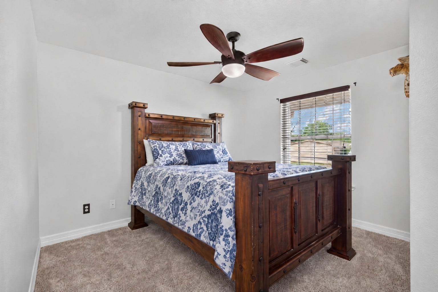 4933 1/2 Powers Ln, Alvin, TX 77511 Spacious second bedroom featuring an upgraded ceiling fan and front-yard pond views.