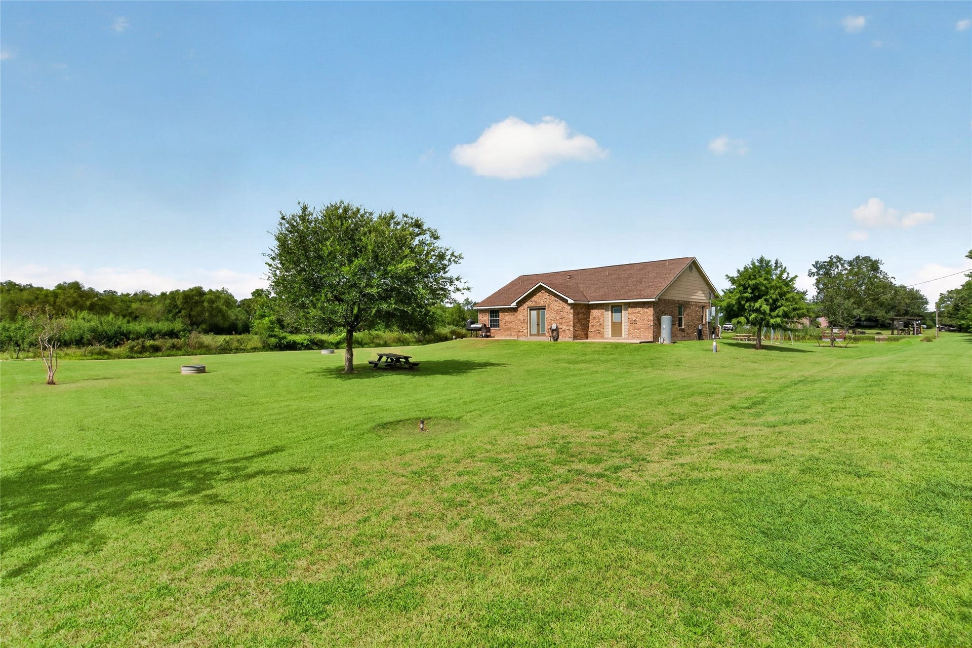 4933 1/2 Powers Ln, Alvin, TX 77511 Enjoy two separate back patios with direct access from the kitchen and the primary bedroom
