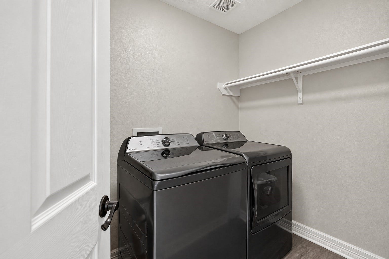 4933 1/2 Powers Ln, Alvin, TX 77511 Generous laundry room offering built-in storage and hanging space for added functionality.