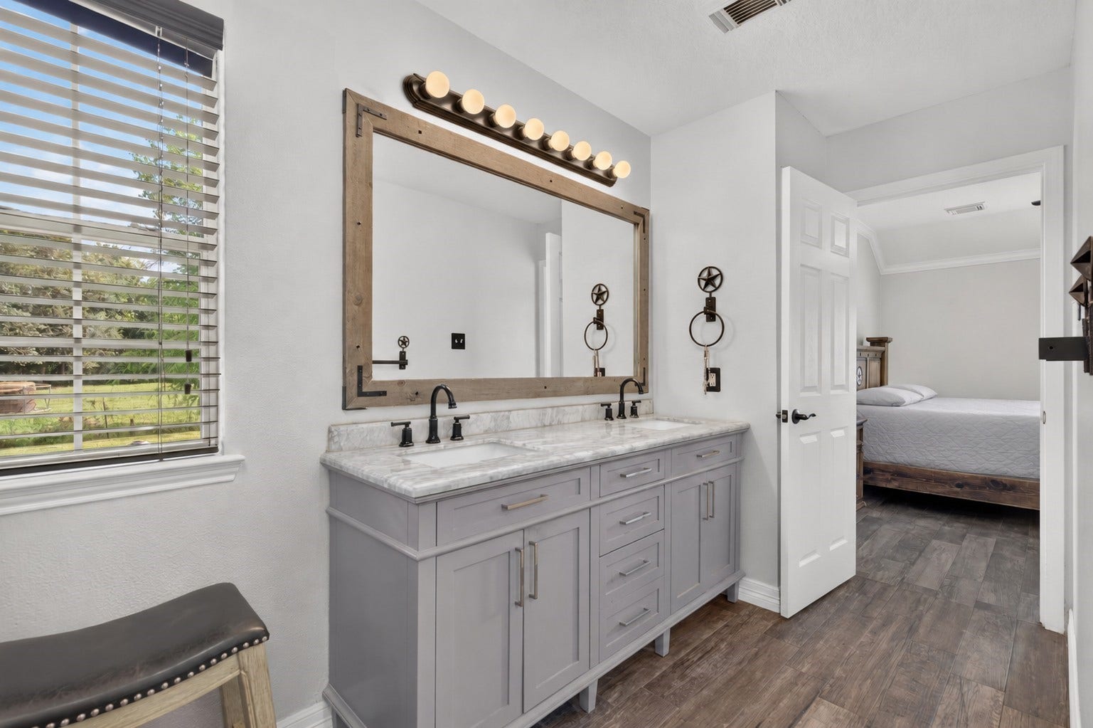 4933 1/2 Powers Ln, Alvin, TX 77511 Completely updated en-suite bath featuring dual sinks, vanity, stylish fixtures, and a bright, spacious layout.