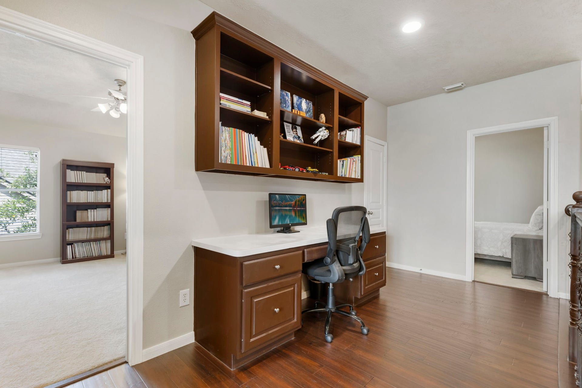 14 N Bardsbrook Circle, The Woodlands, TX 77382 A convenient upstairs built-in desk area offers the perfect space for homework, studying, or a dedicated work-from-home setup.