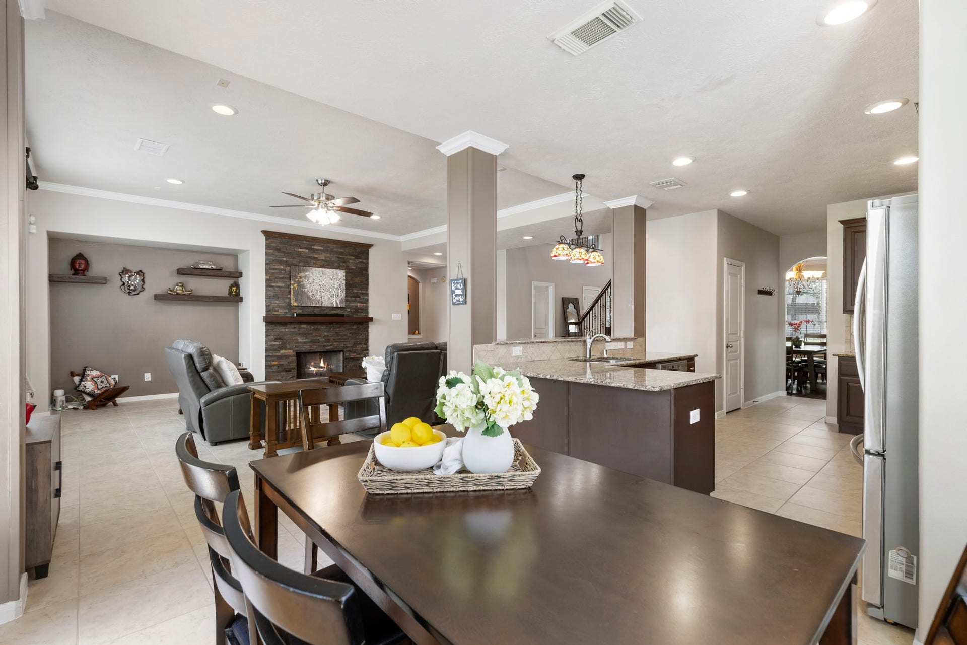 14 N Bardsbrook Circle, The Woodlands, TX 77382 The open-concept design connects the kitchen, breakfast area, and living room, creating the perfect layout for gathering and entertaining.