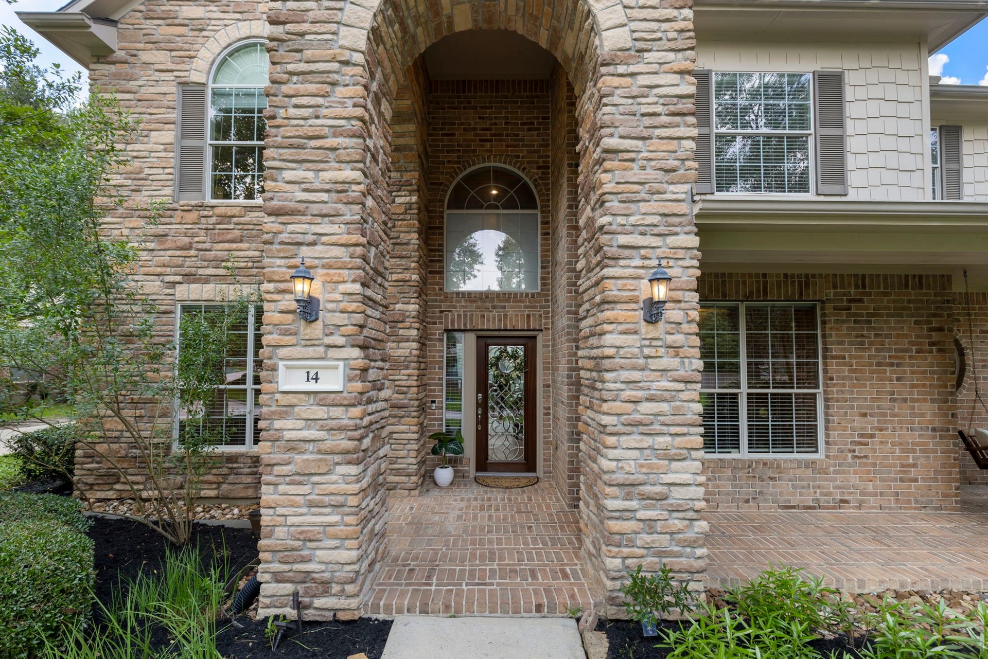 14 N Bardsbrook Circle, The Woodlands, TX 77382 A charming covered front porch and impressive entry create the perfect blend of elegance and warmth before you even step inside.