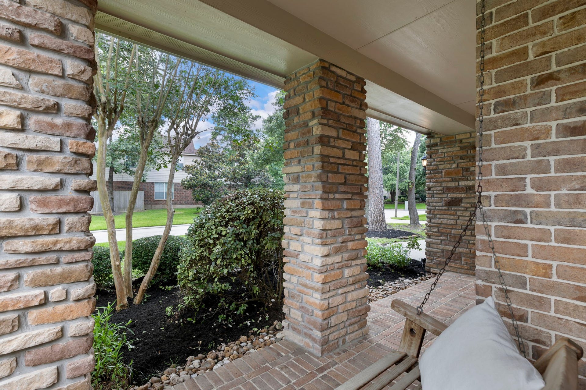 14 N Bardsbrook Circle, The Woodlands, TX 77382 Imagine starting your mornings on this charming covered front porch swing, sipping coffee and enjoying the peaceful surroundings beneath the shade of mature trees.