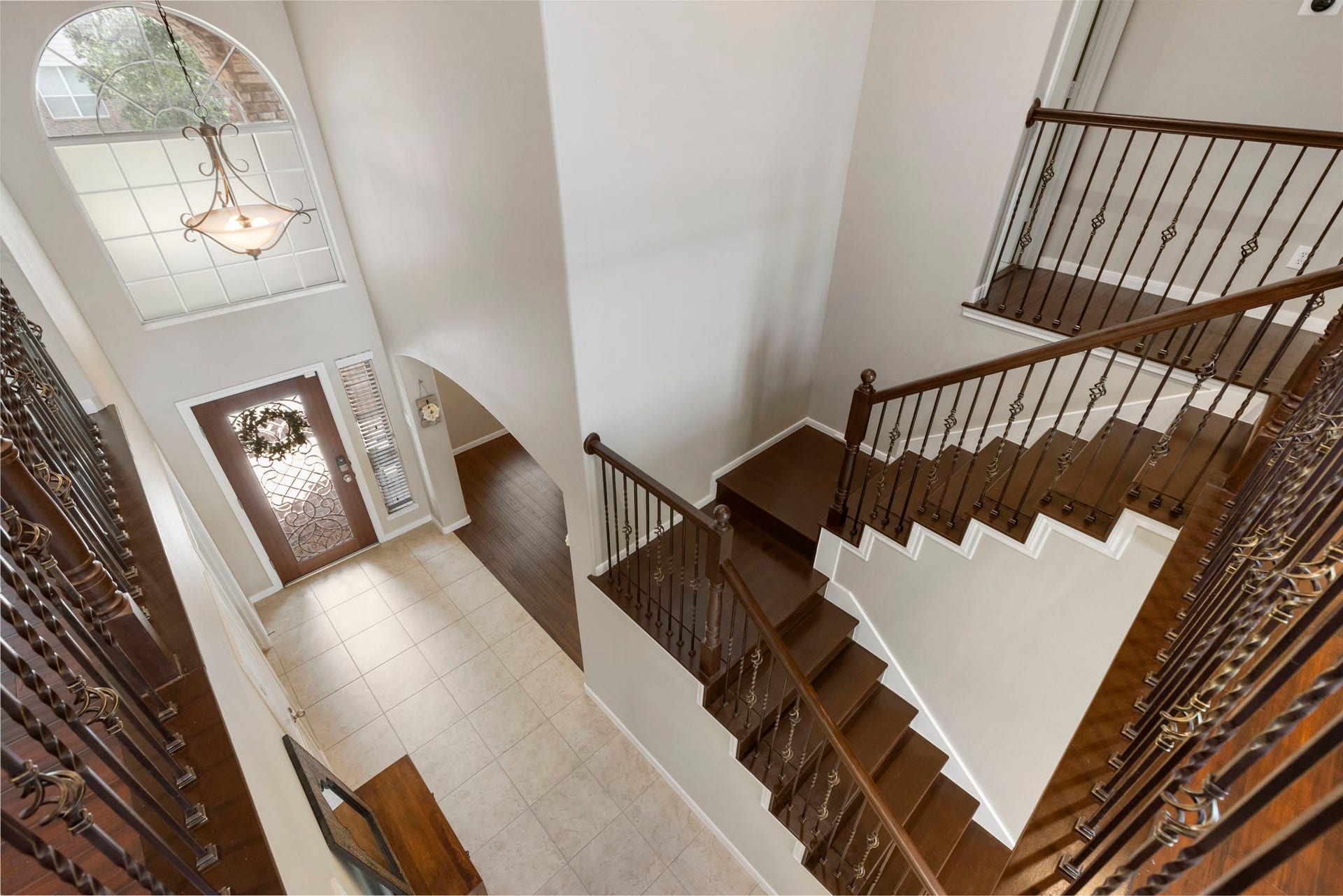 14 N Bardsbrook Circle, The Woodlands, TX 77382 Heading upstairs, the timeless wrought iron staircase leads to four spacious secondary bedrooms and a large game room.