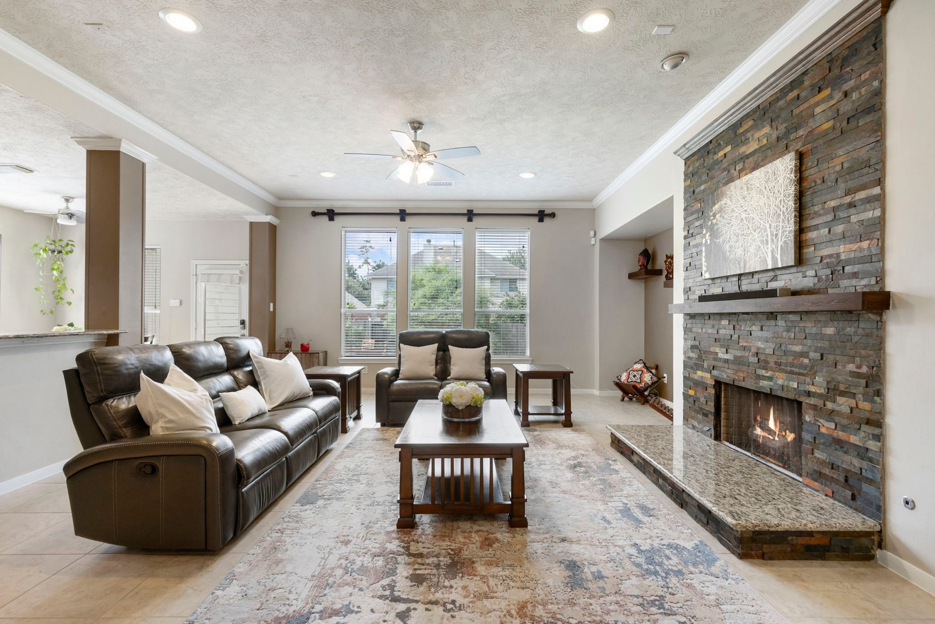 14 N Bardsbrook Circle, The Woodlands, TX 77382 Designed with comfort in mind, the spacious family room offers a warm atmosphere with a stunning fireplace as the centerpiece.
