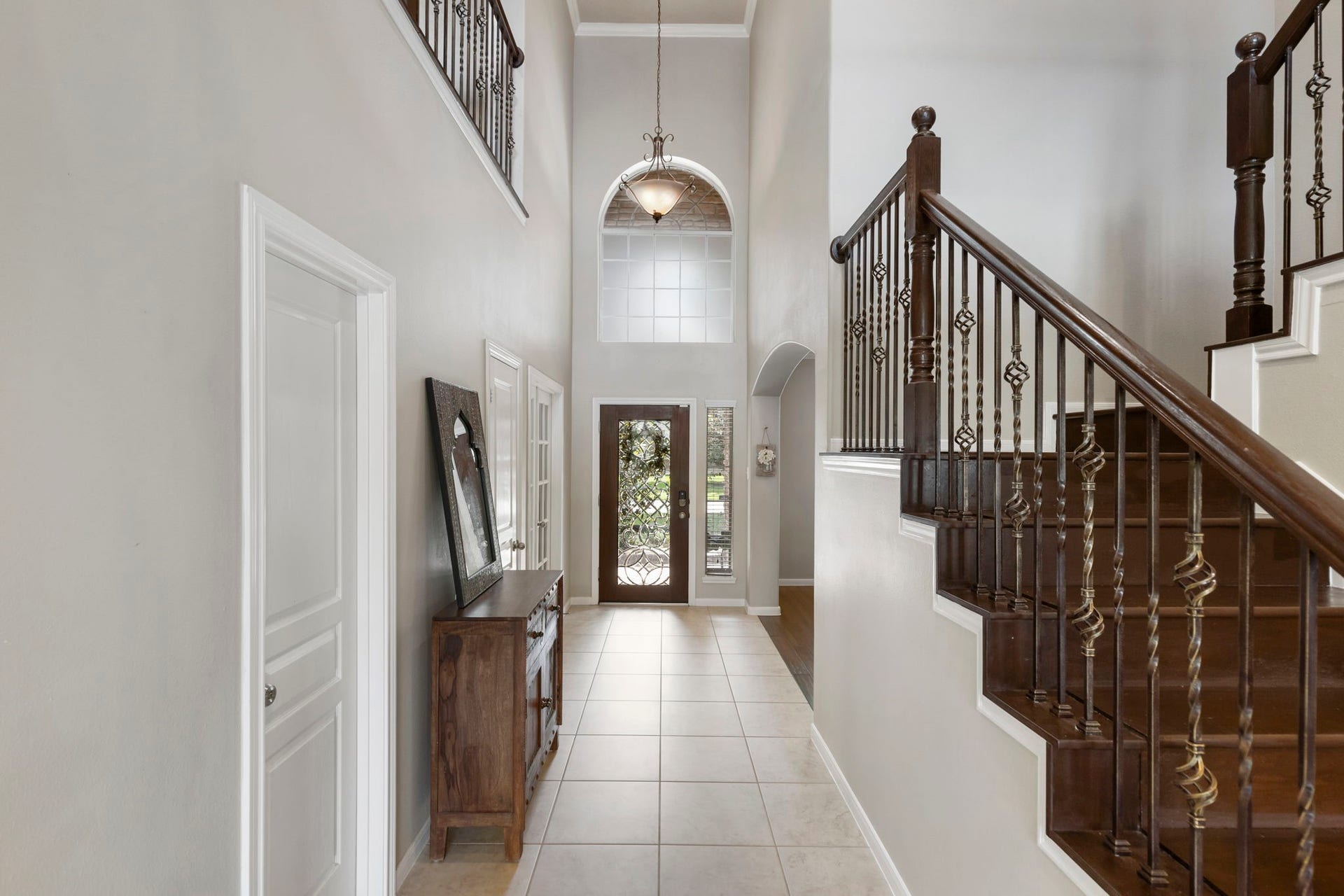 14 N Bardsbrook Circle, The Woodlands, TX 77382 The grand foyer showcases elegant details including a wrought iron staircase, high ceilings, and timeless character that makes a lasting first impression.