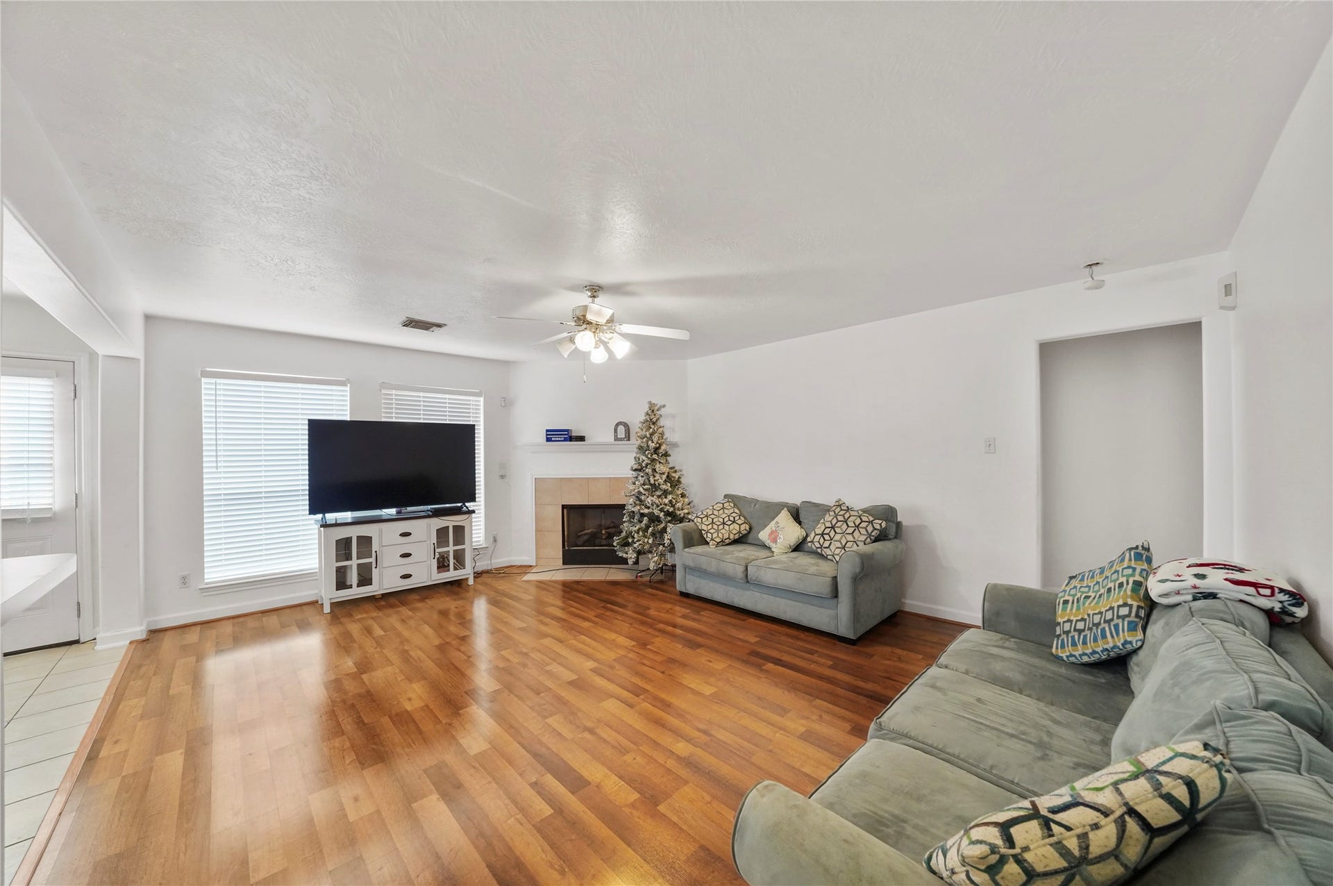 5614 Gaffney Lane, Houston, TX 77084 Warm laminate flooring carries through the living room, where an open layout leaves room for gathering, relaxing, and keeping conversation connected to the kitchen.