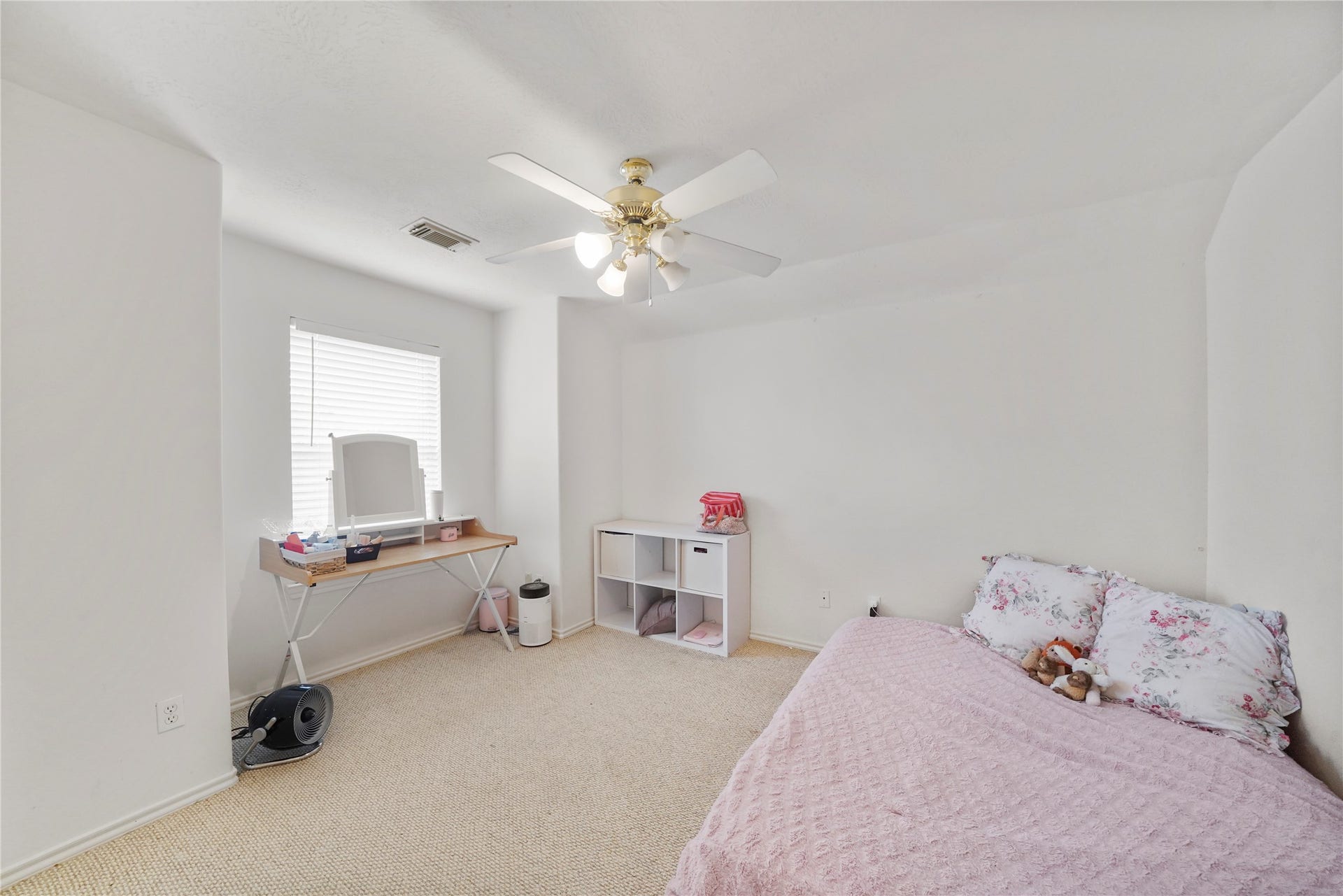 5614 Gaffney Lane, Houston, TX 77084 This secondary bedroom has a bright window, ceiling fan, and a neutral backdrop that can grow with changing needs.