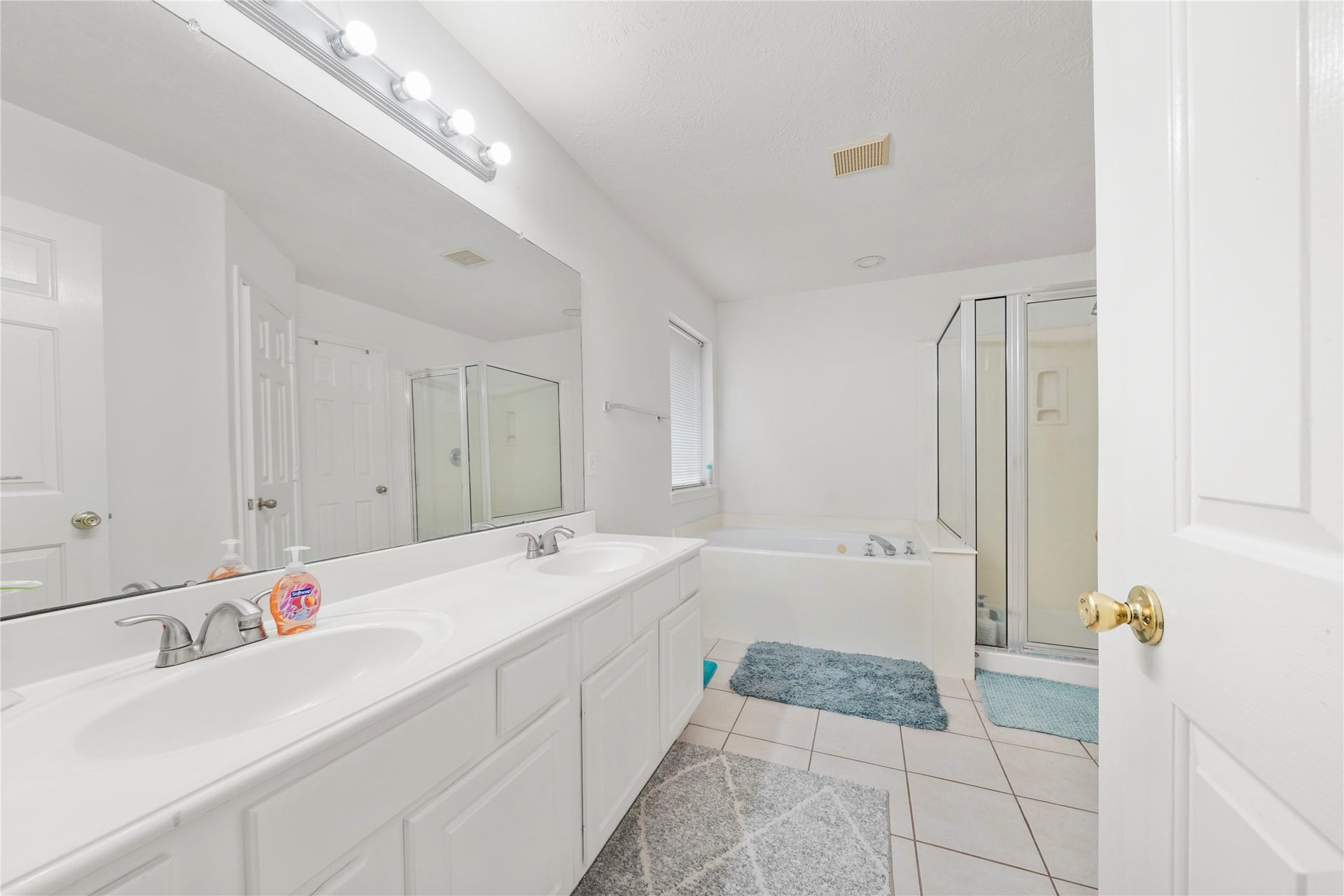 5614 Gaffney Lane, Houston, TX 77084 The primary bath begins with an extended dual-sink vanity, bringing useful counter space and storage to the everyday routine.