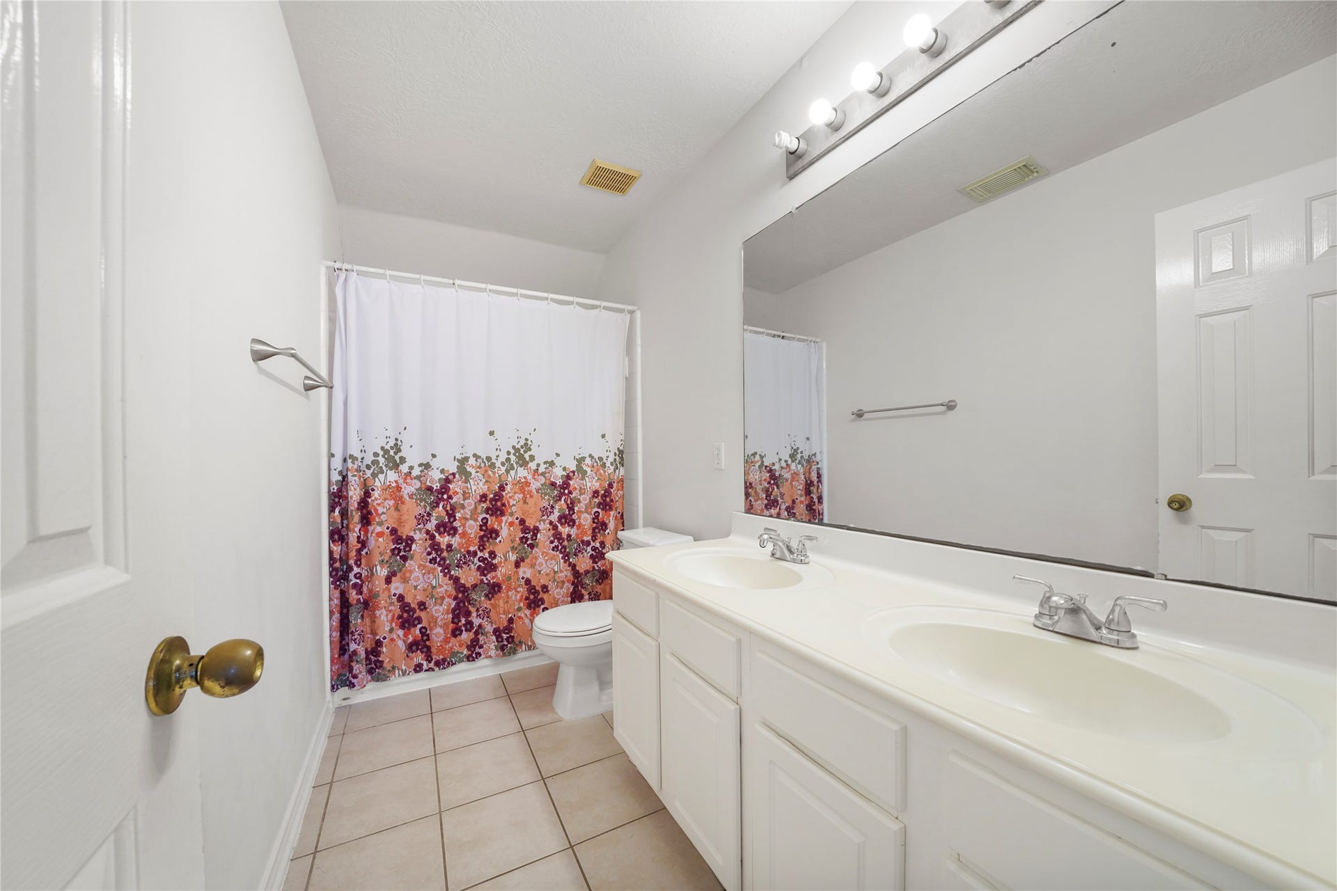 5614 Gaffney Lane, Houston, TX 77084 The shared upstairs bath pairs a double-sink vanity with a tub/shower combination to help the day start and end with ease.