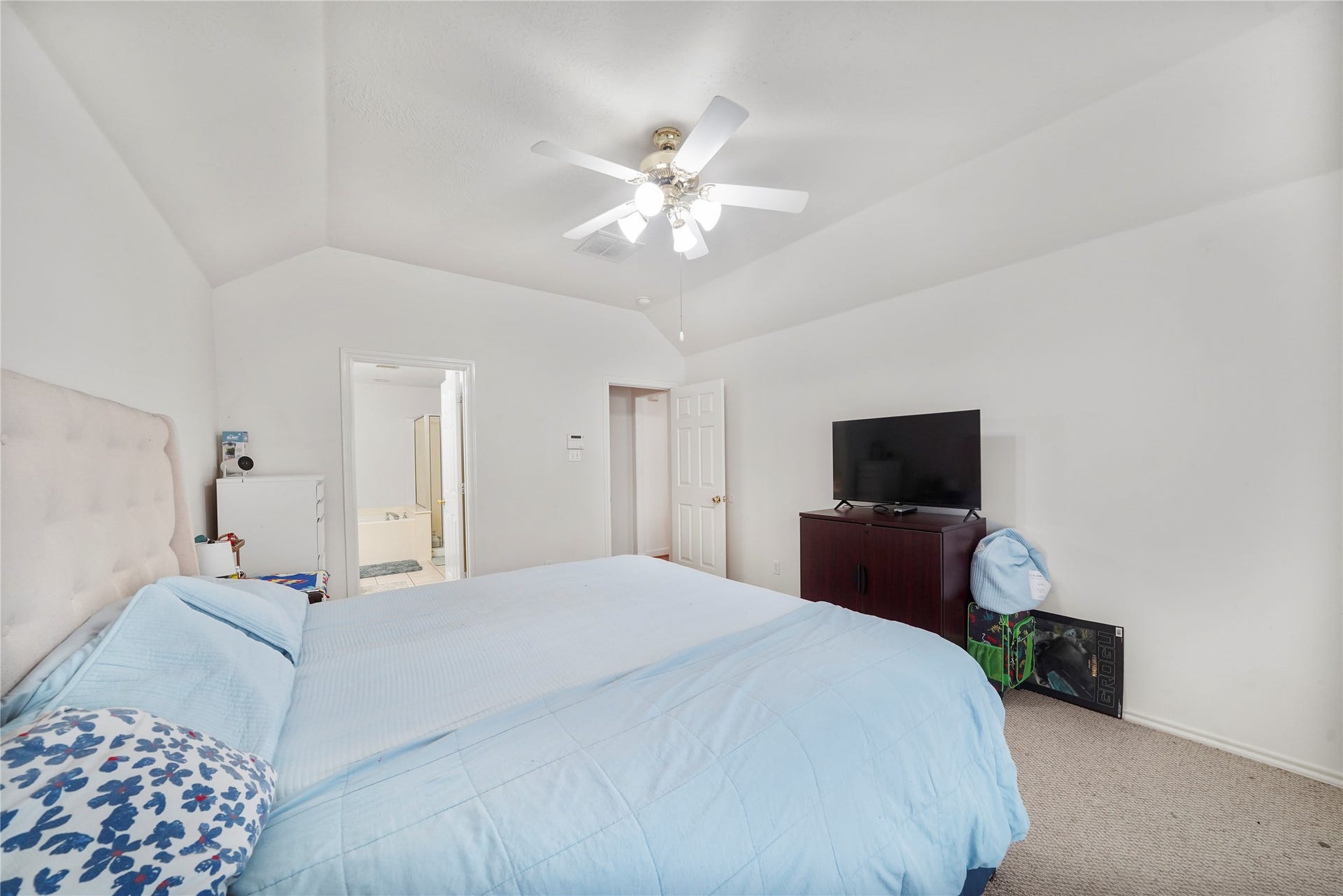 5614 Gaffney Lane, Houston, TX 77084 Another view of the primary bedroom captures its peaceful scale and flexible wall space for a dresser, media console, or reading chair.