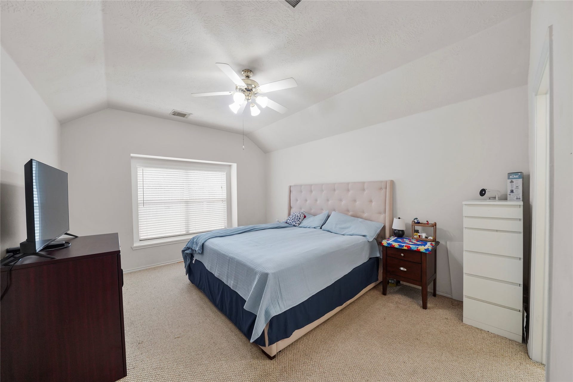 5614 Gaffney Lane, Houston, TX 77084 The primary retreat offers room to settle in comfortably, with a soft neutral palette, ceiling fan, and space for a full furniture arrangement.