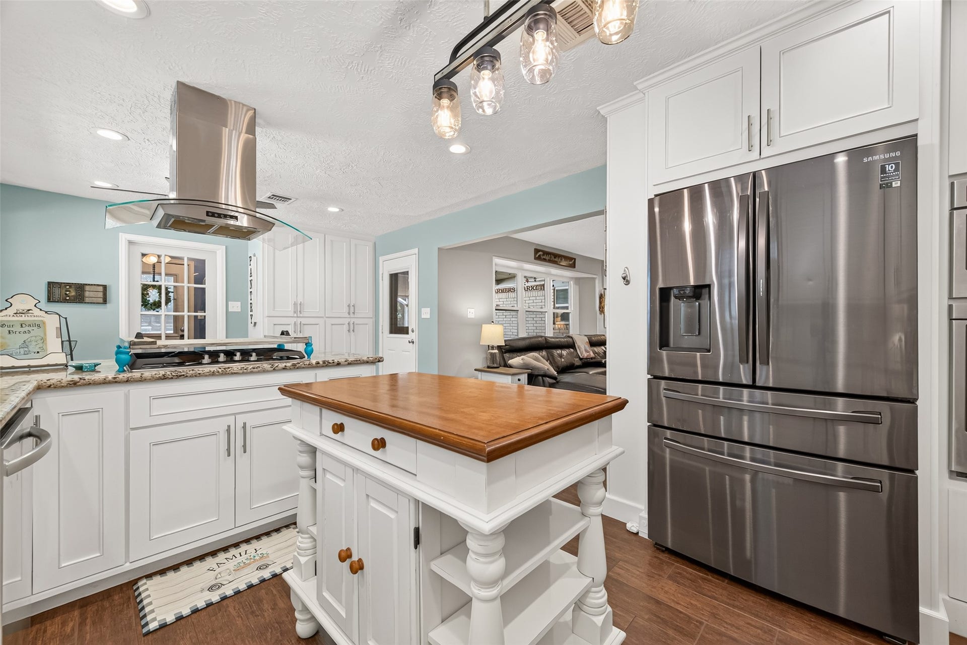1535 Memorial Drive, Conroe, TX 77304 ANOTHER VIEW OF THE KITCHEN, THE GLASS DOOR LEADS TO THE LAUNDRY ROOM, THE DOOR IN THE MIDDLE LEADS TO THE COVER BACK PATIO WITH A CUSTOM BUILT SCREEN DOOR AND THE LIVING ROOM TO THE RIGHT;