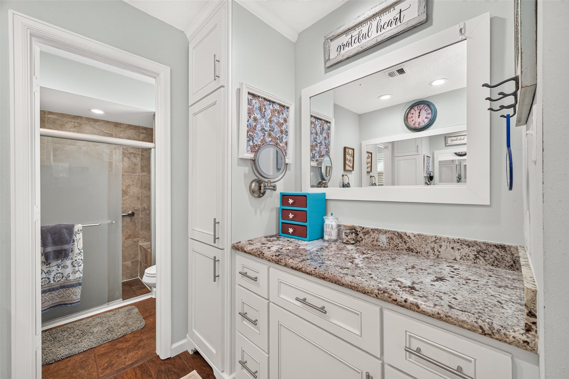 1535 Memorial Drive, Conroe, TX 77304 ANOTHER VIEW OF THE VANITY AREA IN THE PRIMARY BATHROOM; LOTS OF DRAWERS AND CABINET SPACE; WALK IN SHOWER WITH SEATING INSIDE; A WINDOW FOR NATURAL LIGHT