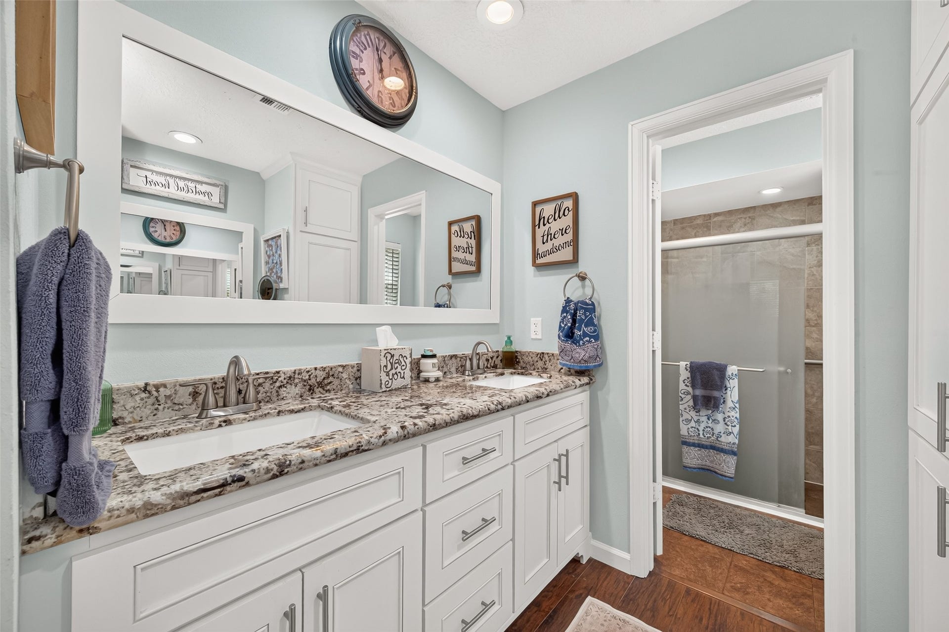 1535 Memorial Drive, Conroe, TX 77304 PRIMARY BATHROOM WITH DOUBLE SINKS, GRANITE COUNTERTOPS, LOTS OF CABINET SPACE AND ENTRY TO THE SHOWER AND TOILET;