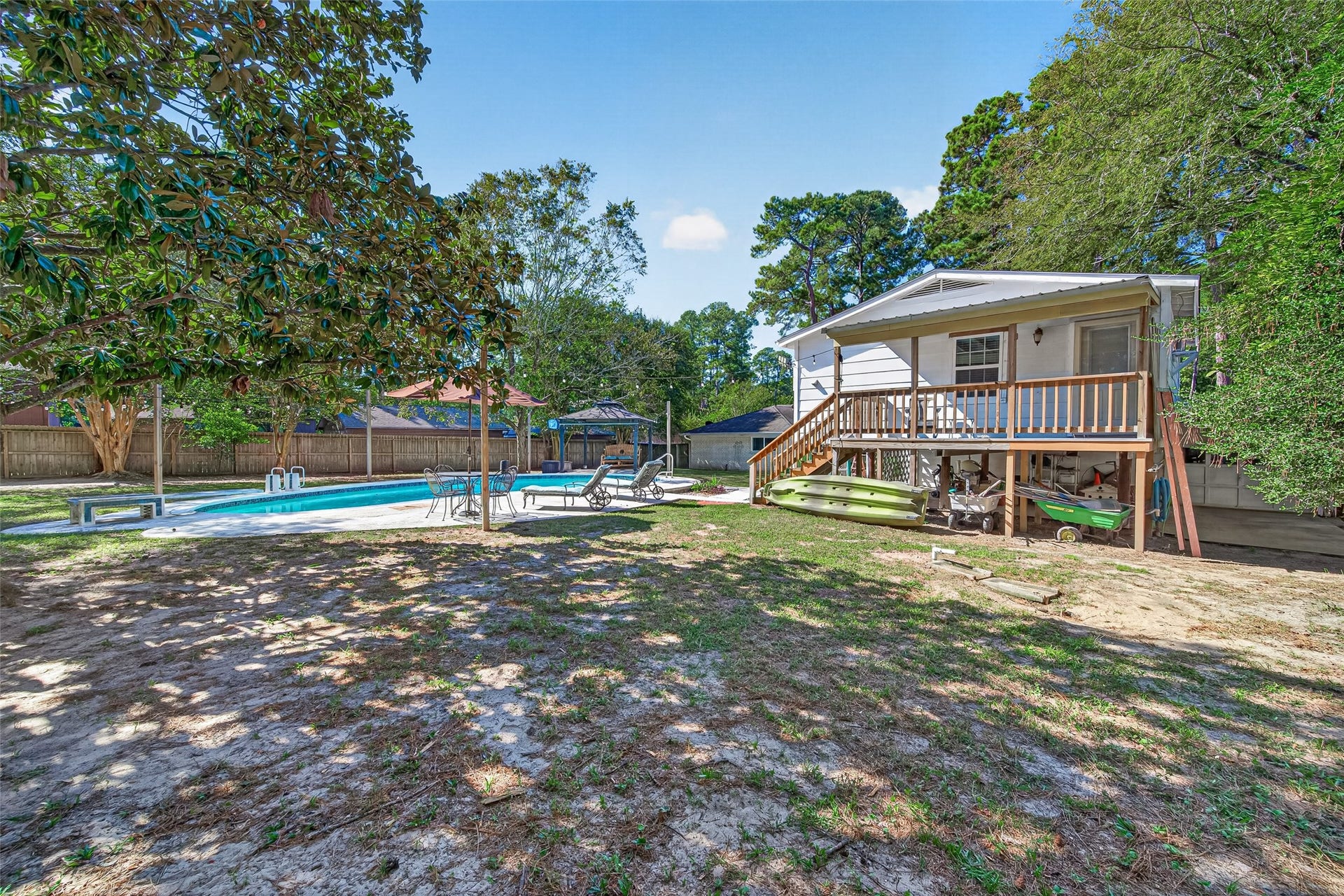 1535 Memorial Drive, Conroe, TX 77304 ANOTHER VIEW OF THE BACK YARD AND POOL HOUSE ON THE LEFT. AND LOTS OF SPACE TO STORE ALL YOUR OUTDOOR ITEMS UNDER THE POOL HOUSE.