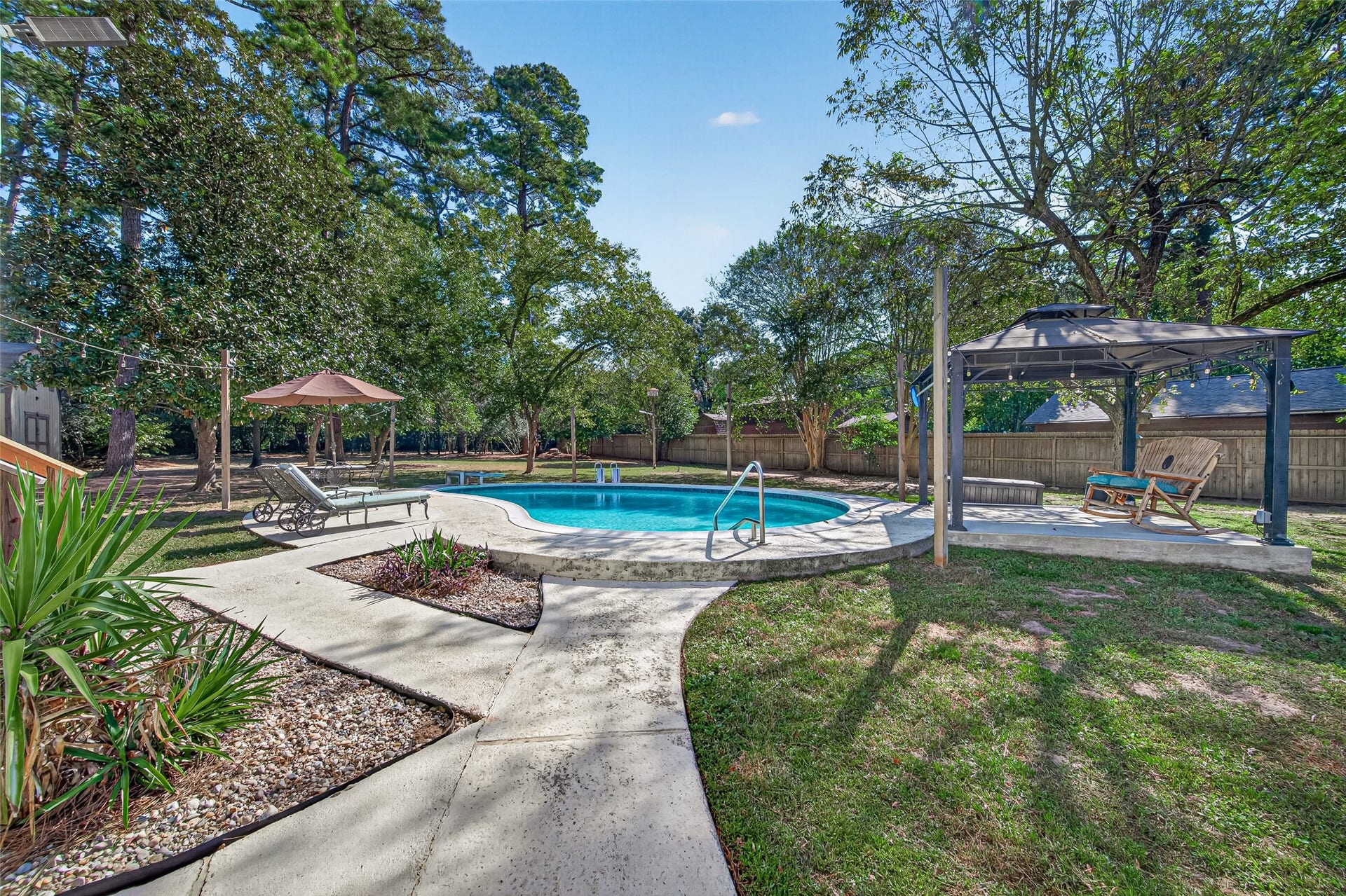 1535 Memorial Drive, Conroe, TX 77304 ARE YOU READY TO SPEND THE DAY AT THE POOL? AT THIS HOME, ALL YOU HAVE TO DO IS WALK OUT TO YOUR BACKYARD! CUSTOM UPGRADES INCLUDE: 10' X 10' (APPROX) CONCRETE PAD AND ATTACHED GAZEBO W/GFCI OUTLETS, CEILING FAN AND LIGHTS. ALL HANGING LIGHTS WILL REMAIN WITH HOME. TWO (2) LOUNGE CHAIRS W/CUSHIONS WILL REMAIN WITH HOME. (EXCLUSIONS: PATIO SET W/ UMBRELLA)