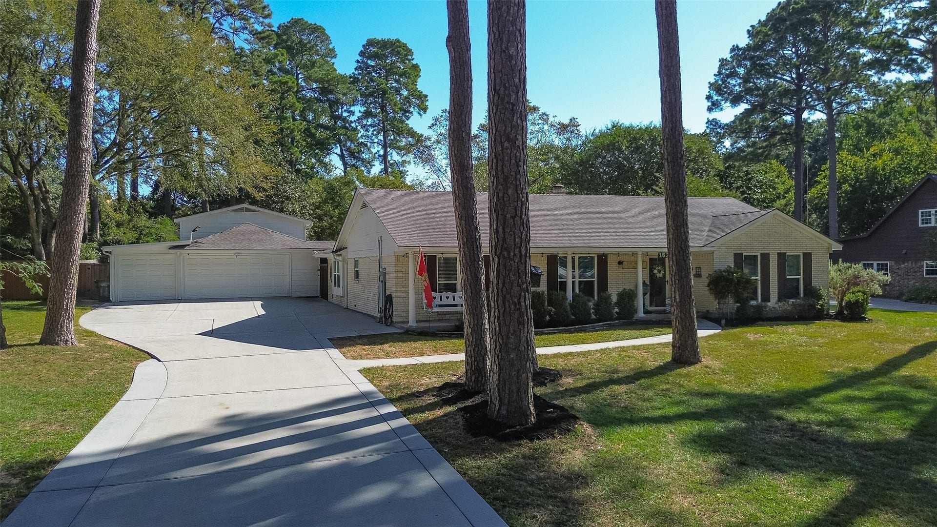 1535 Memorial Drive, Conroe, TX 77304 THREE (3) CAR GARAGE WITH AUTOMATIC GARAGE DOOR OPENERS; AS WELL AS THE SINGLE BAY DRIVES ALL THE WAY THROUGH TO A COVERED CARPORT