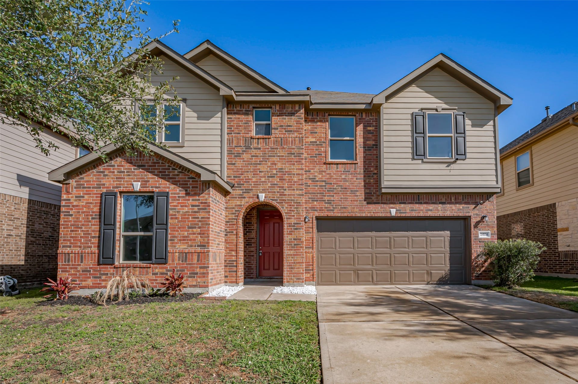 24114 Morrison Lane, Katy, TX 77493 Two-story home with an attached two-car garage and a beautiful yard.