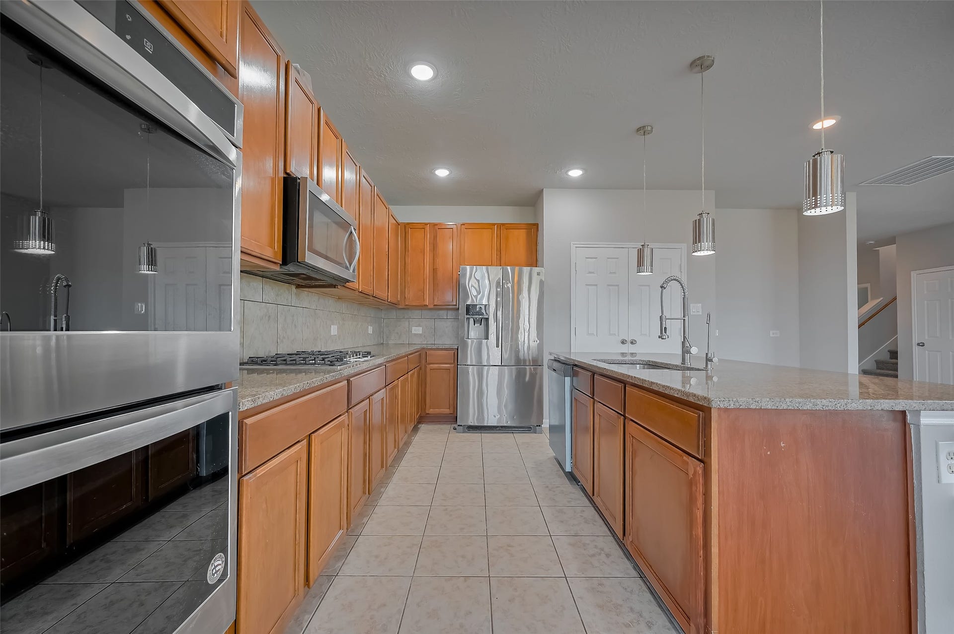 24114 Morrison Lane, Katy, TX 77493 Kitchen with generous wood cabinetry and a large island.