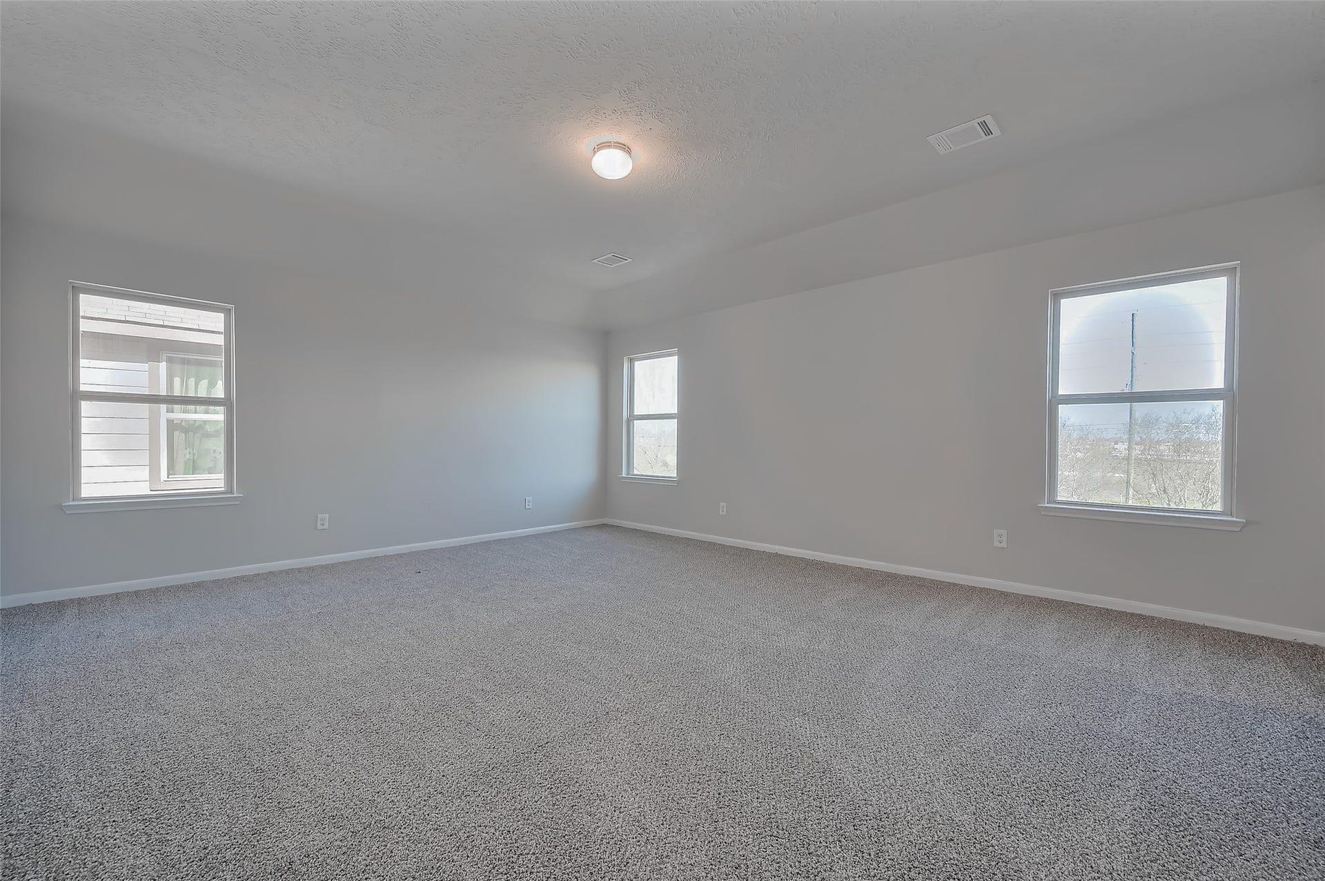 24114 Morrison Lane, Katy, TX 77493 Primary bedroom featuring three large windows.