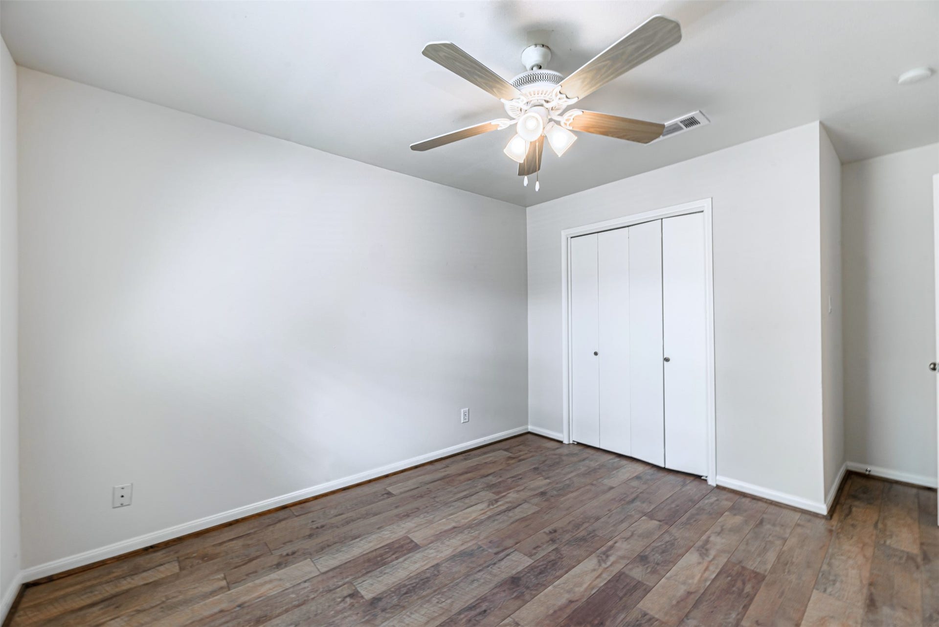 124 Dogwood Street, Sugar Land, TX 77478 The third bedroom, with comfortable closets, beautiful floors and newly installed fans.
