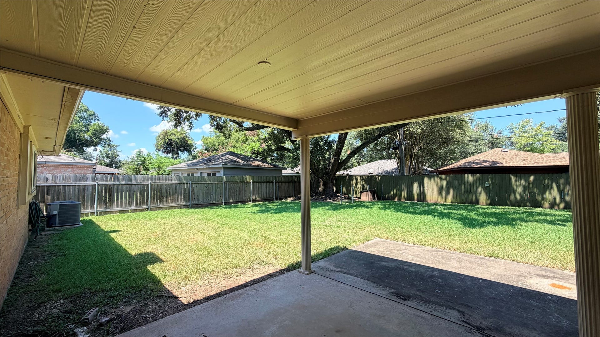 124 Dogwood Street, Sugar Land, TX 77478 Step from the bright, open living space onto a patio that offers serene views of the lush backyard, perfect for relaxation and outdoor gatherings.