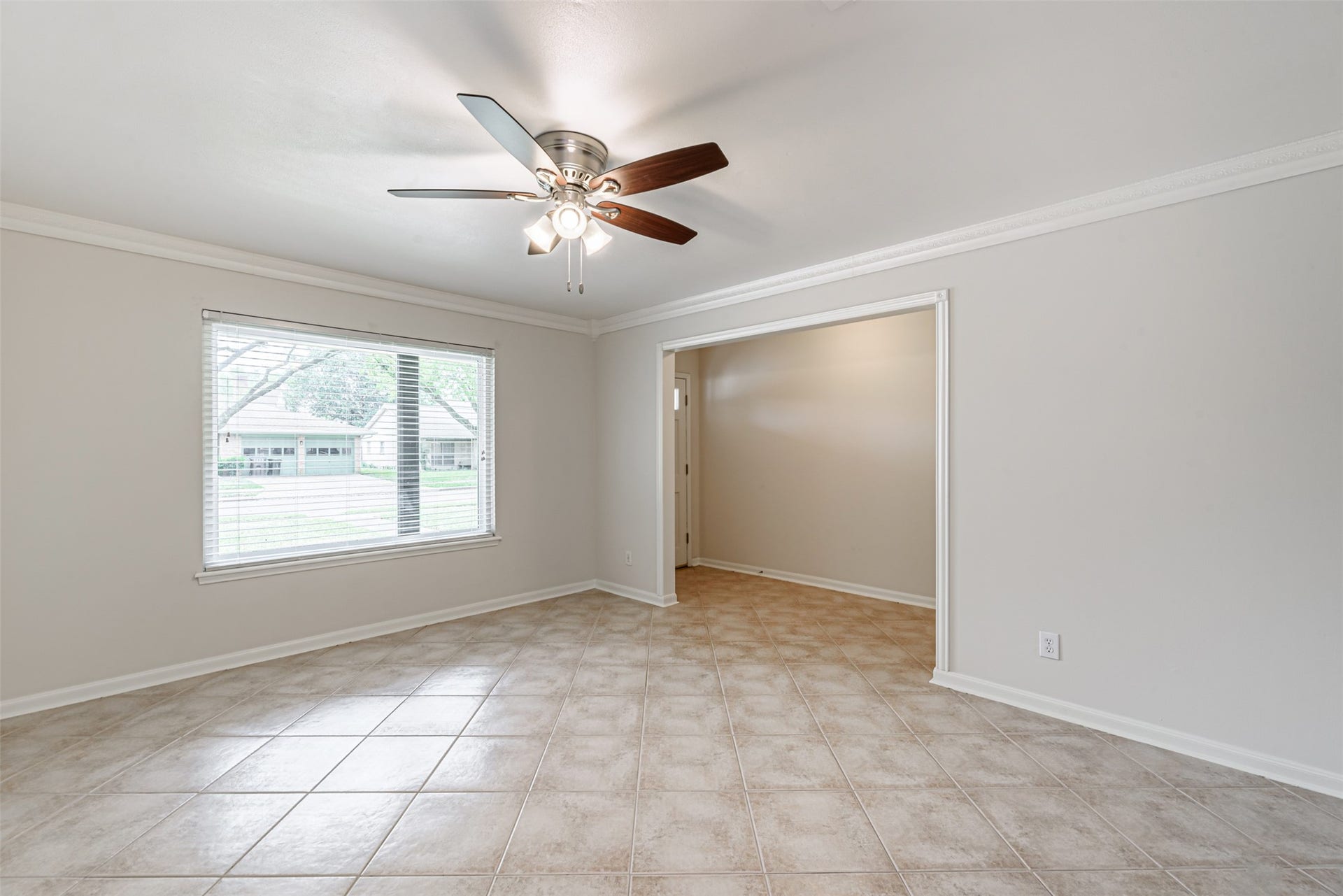 124 Dogwood Street, Sugar Land, TX 77478 Elegant open-plan view from the family room to the formal living area, seamlessly guiding you through the hallway to the inviting main entrance.