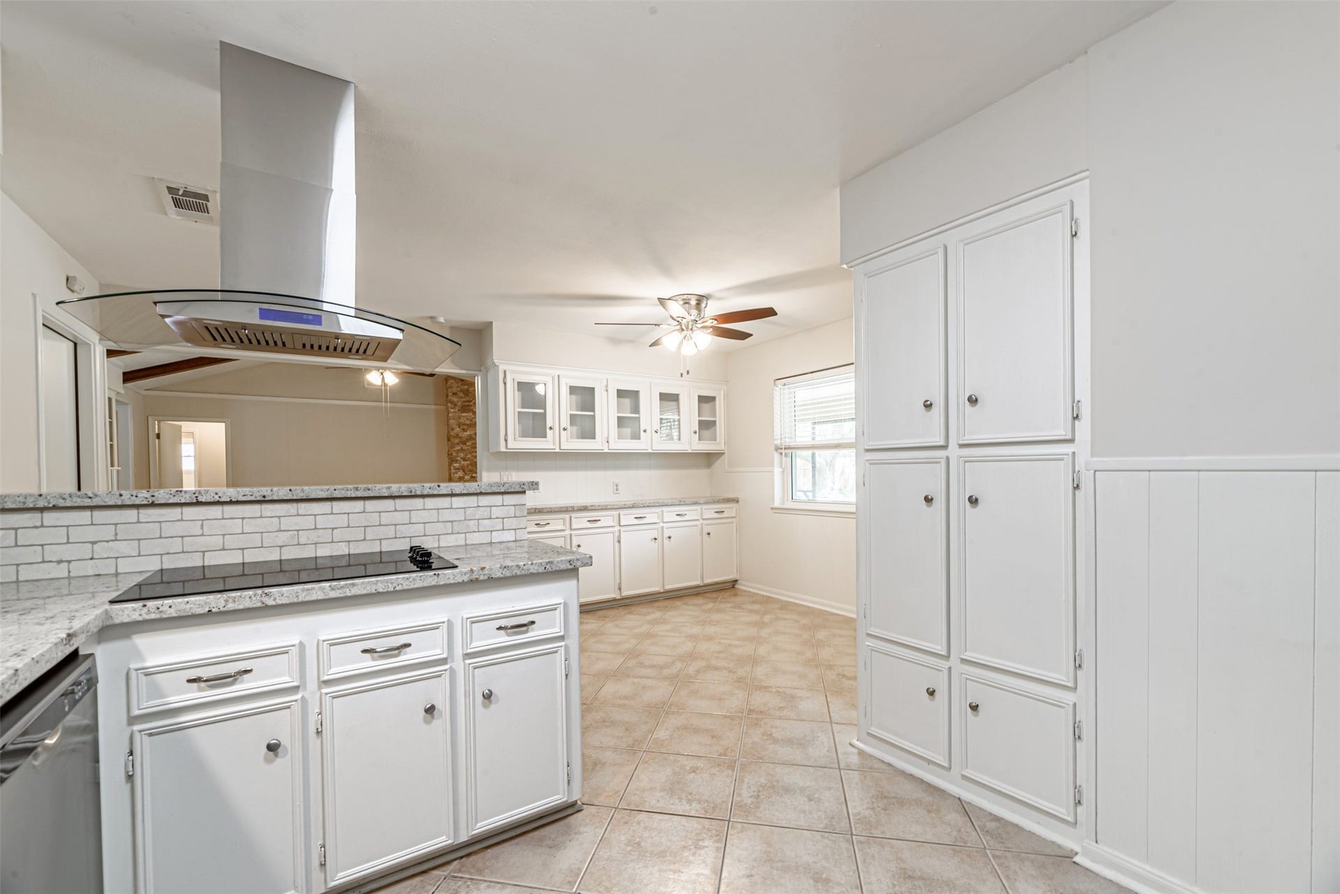 124 Dogwood Street, Sugar Land, TX 77478 Discover modern culinary elegance with an electric cooktop and sleek stainless steel appliances, perfectly complementing the bright and spacious kitchen.