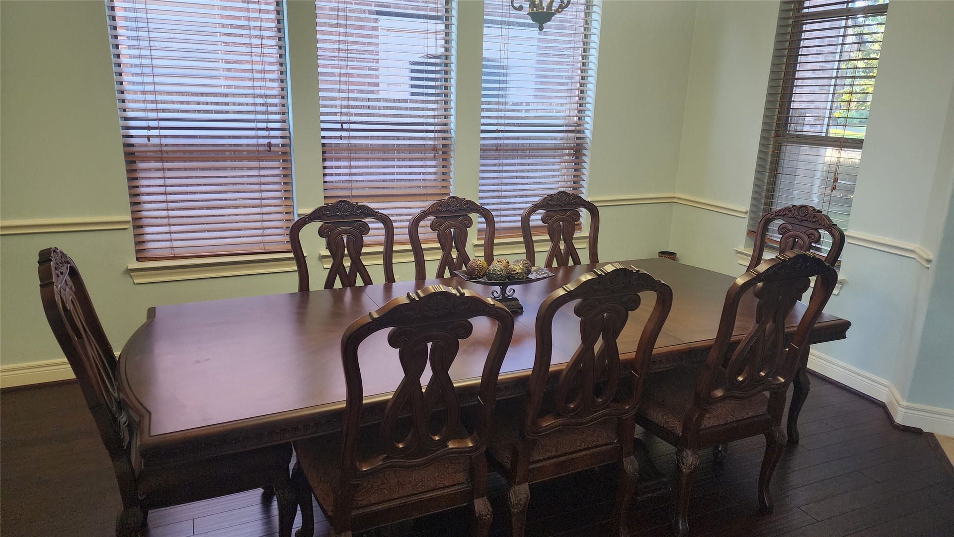 5442 Faircreek Ln Lane, Katy, TX 77450 Elegant dining area featuring a classic wooden table and chairs, bathed in natural light from large windows, perfect for gatherings and memorable meals.