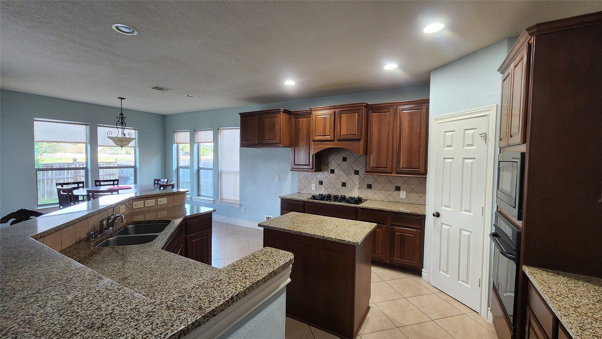 5442 Faircreek Ln Lane, Katy, TX 77450 Discover the heart of the home in this inviting kitchen, featuring rich wooden cabinetry, sleek granite countertops, and a cozy breakfast nook bathed in natural light.
