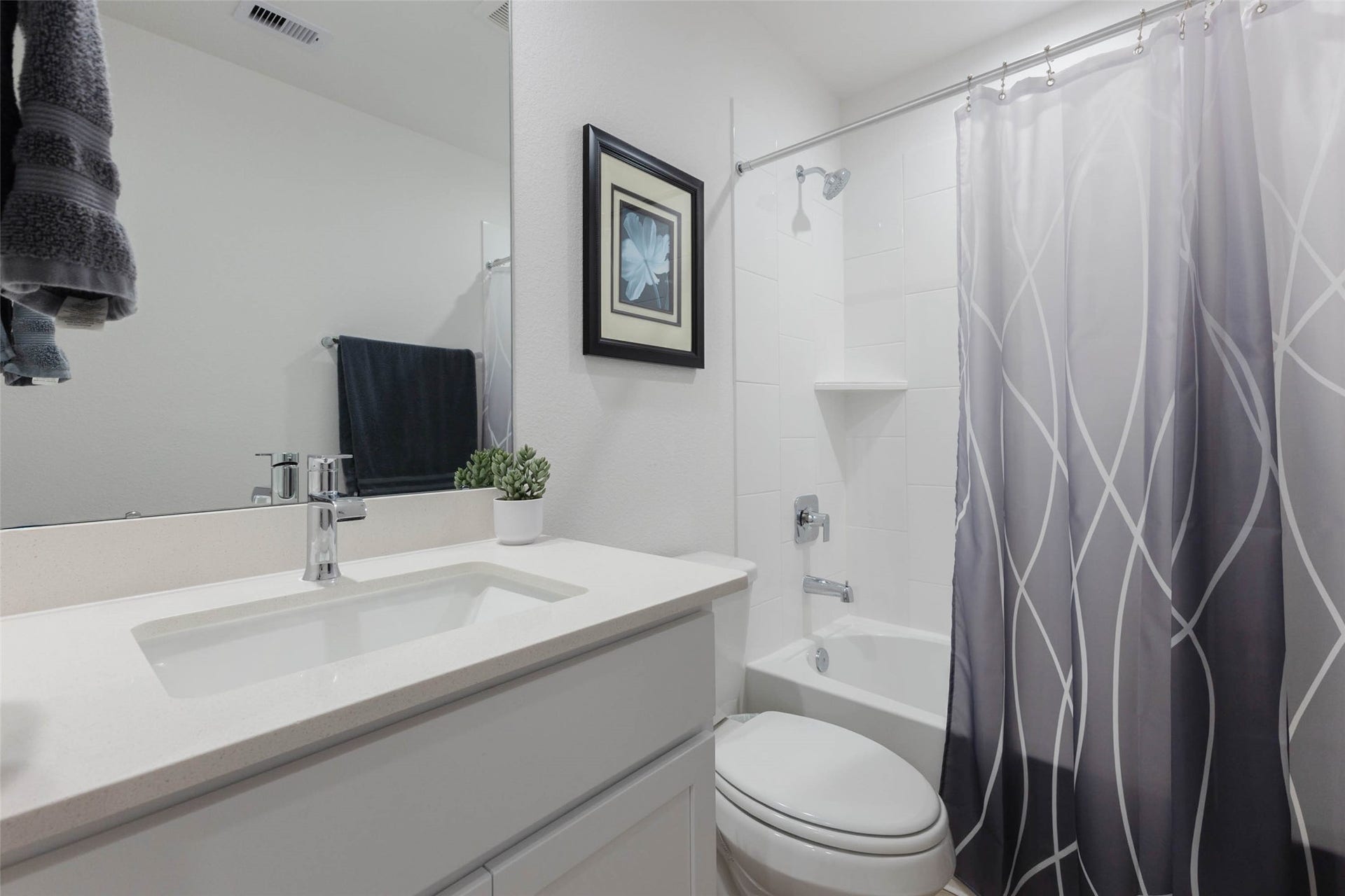 30502 White Cliff Court, Fulshear, TX 77441 Modern bathroom featuring a sleek white vanity, creating a clean and inviting space.