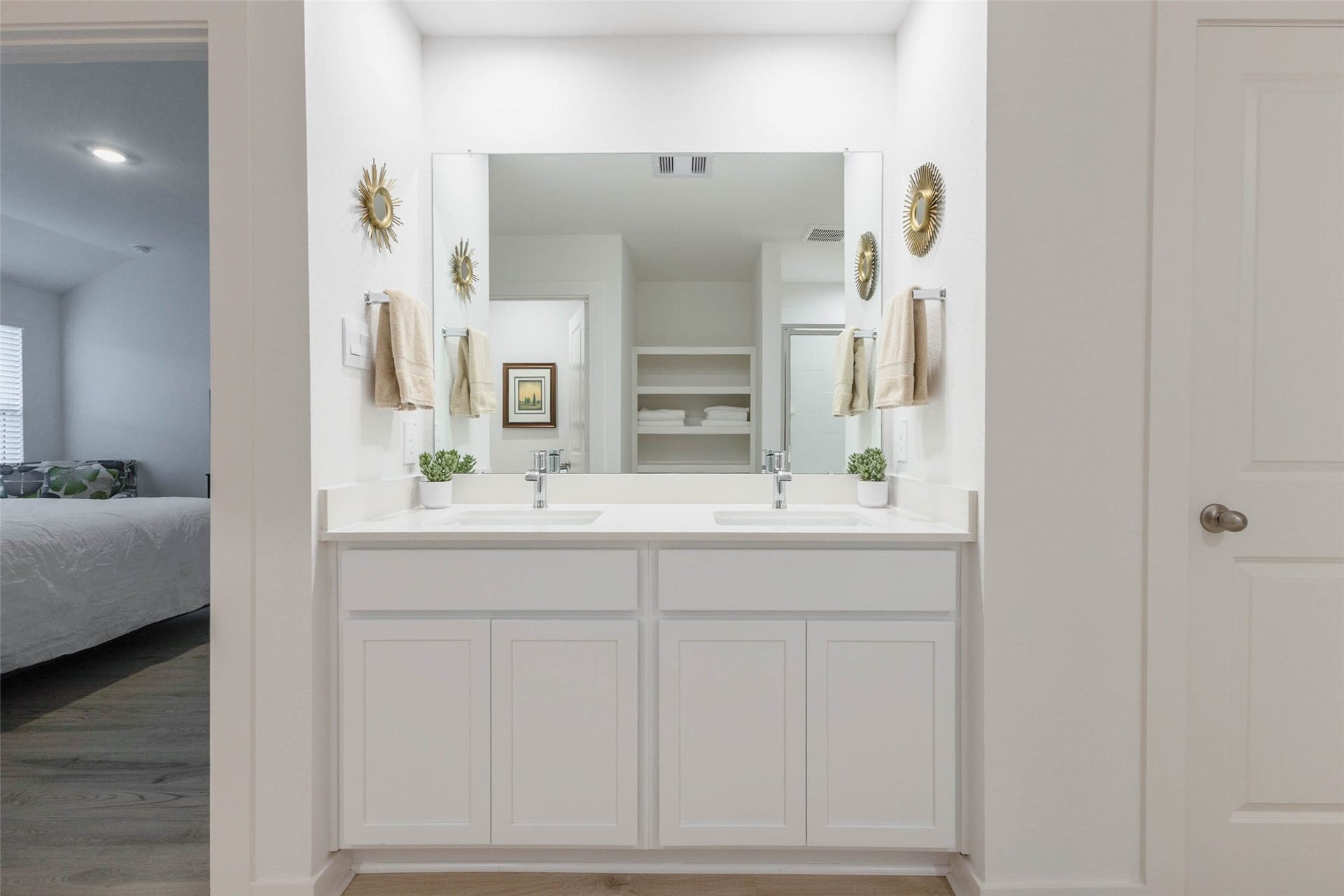 30502 White Cliff Court, Fulshear, TX 77441 Bright and modern bathroom featuring a dual vanity with sleek fixtures, ample storage, and elegant decor, seamlessly connected to the adjacent bedroom.