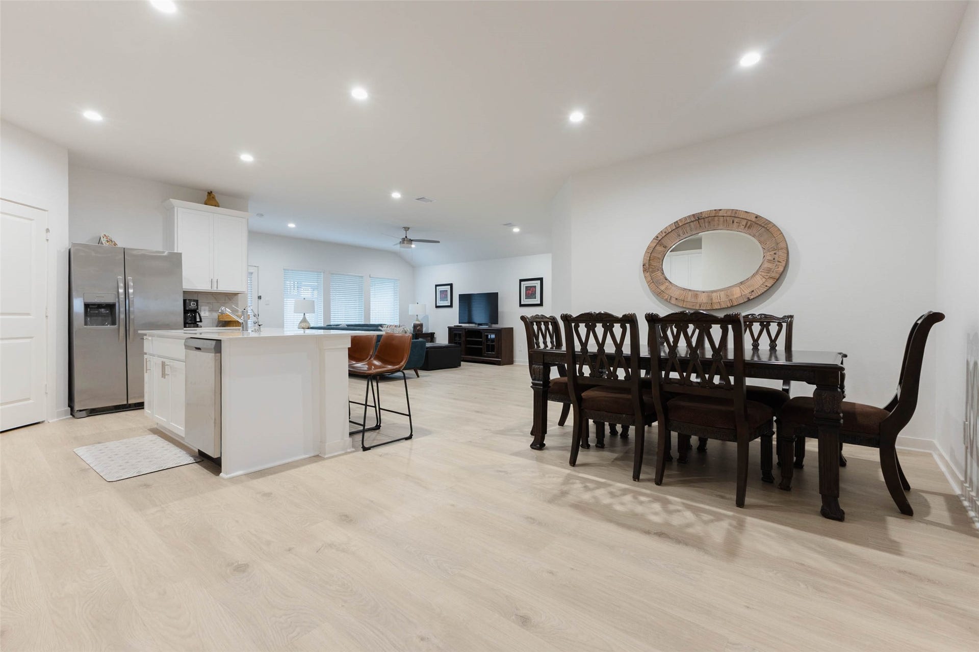 30502 White Cliff Court, Fulshear, TX 77441 Spacious open-concept living area with modern kitchen, featuring a large island, stainless steel appliances, and an elegant dining space perfect for entertaining.