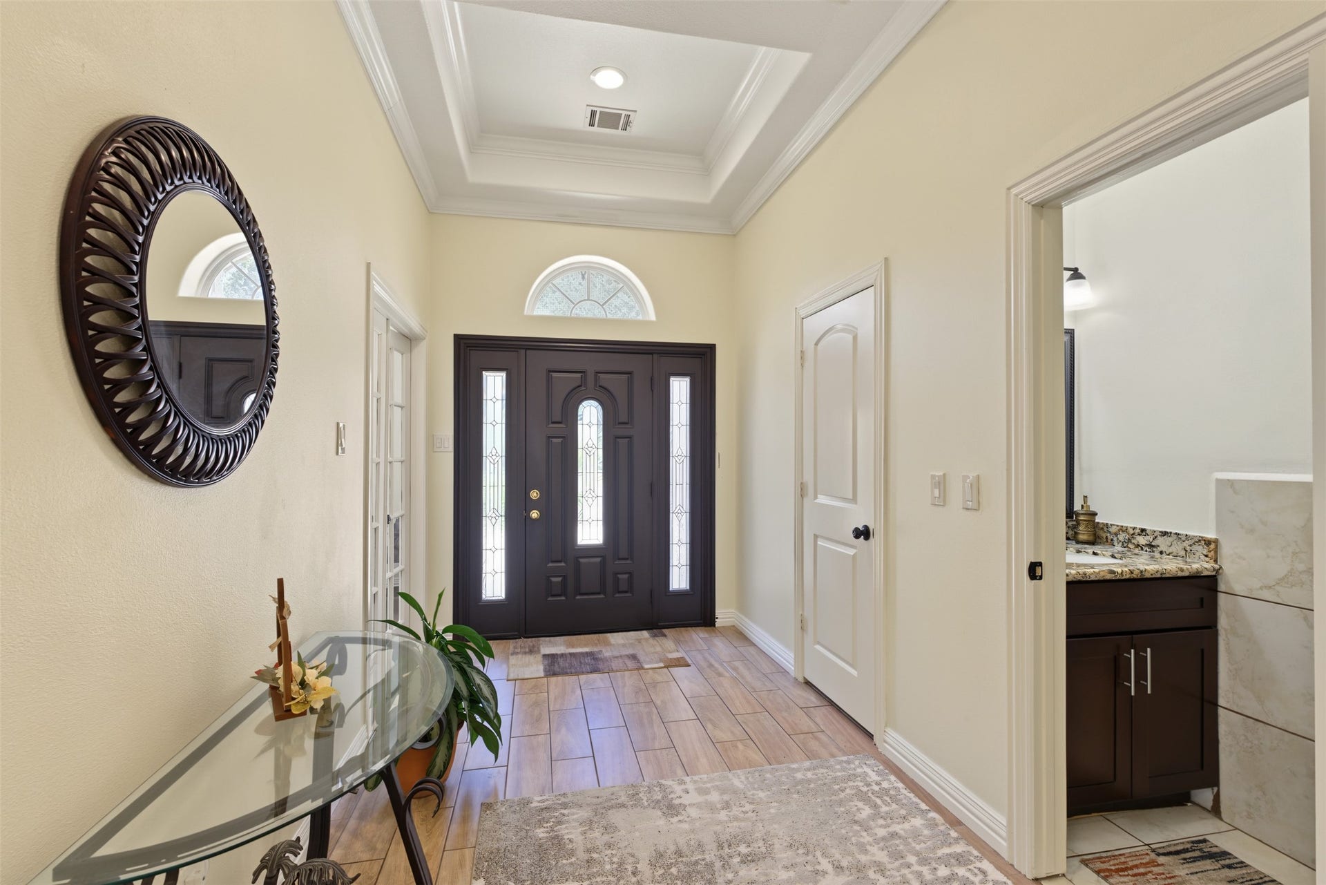 Hall way with a half bath situated close to the entrace