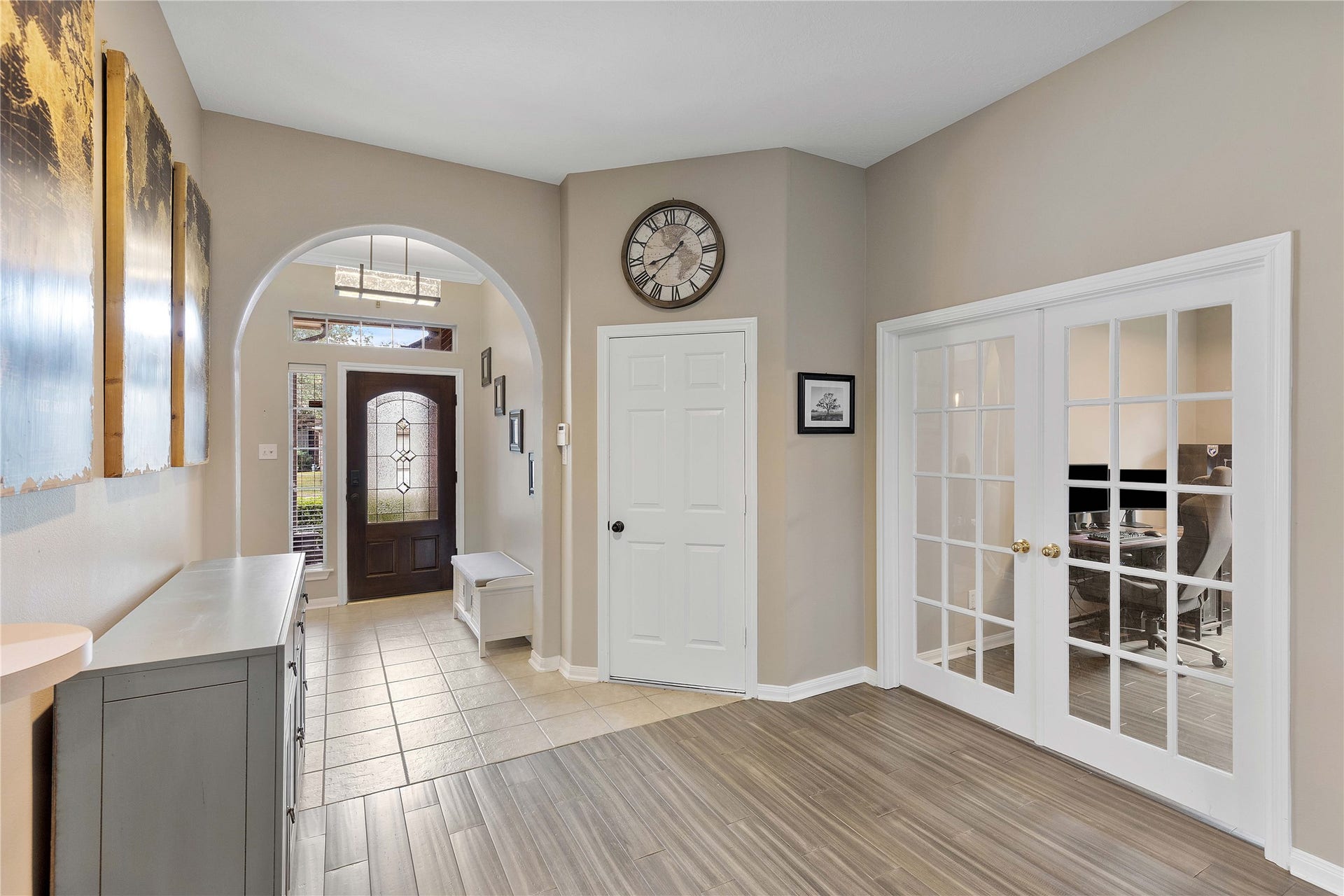 18343 Otter Creek Trail, Humble, TX 77346 Bright entryway with elegant tile flooring, decorative glass front door, and French doors leading to a cozy office space.