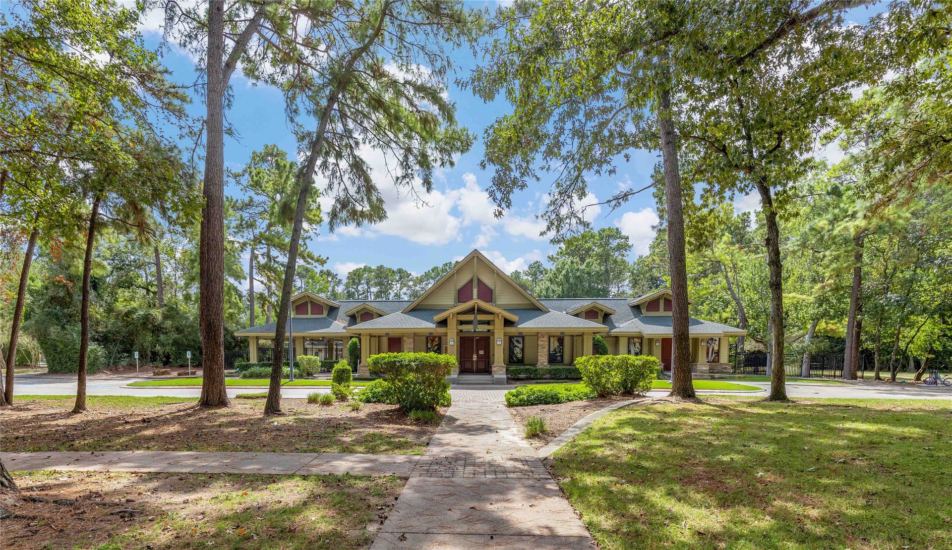 18343 Otter Creek Trail, Humble, TX 77346 Discover the perfect blend of nature and leisure with this inviting clubhouse nestled among lush trees, offering a gateway to exceptional community amenities.