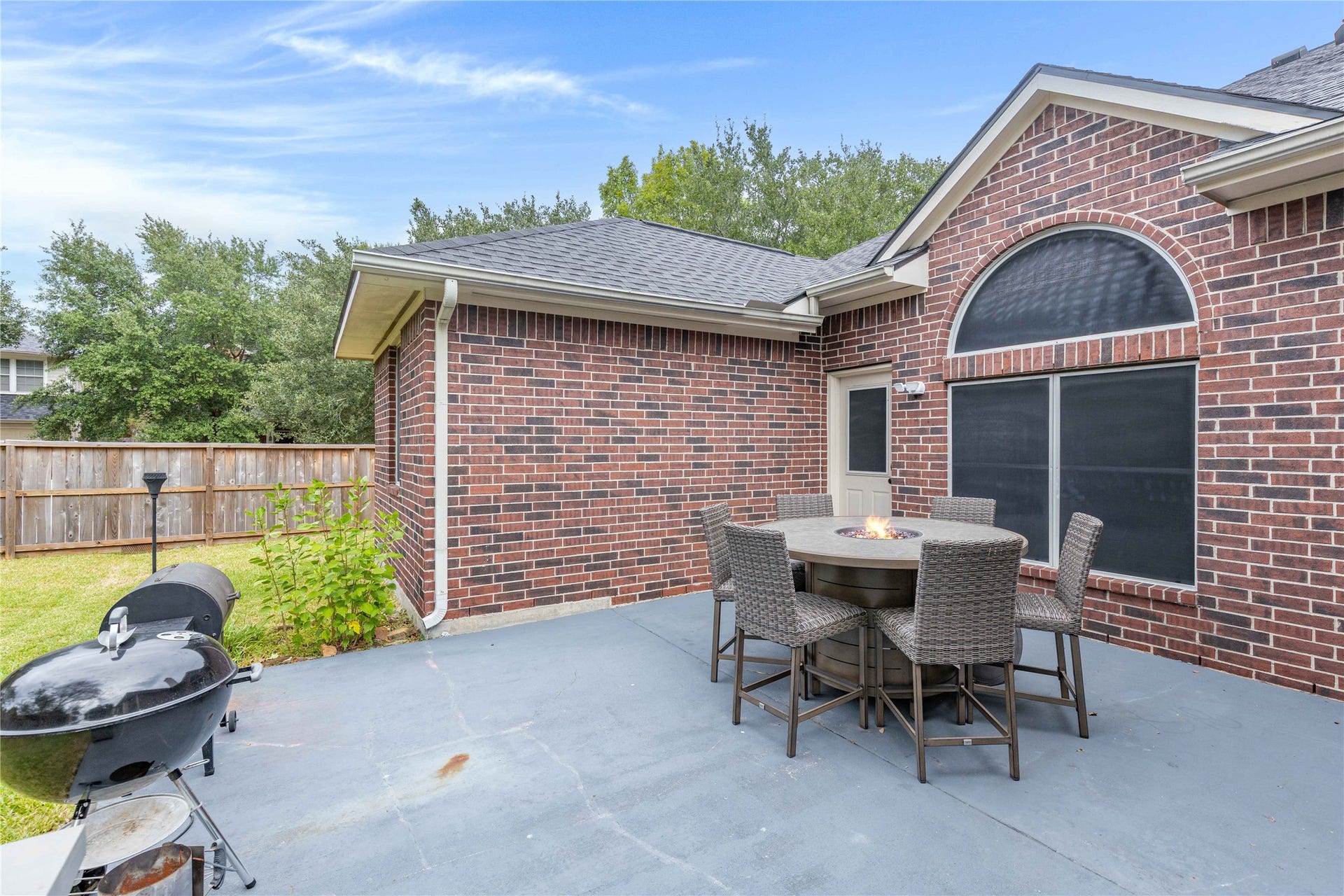 18343 Otter Creek Trail, Humble, TX 77346 Charming backyard patio features a brick patio perfect for outdoor entertaining.