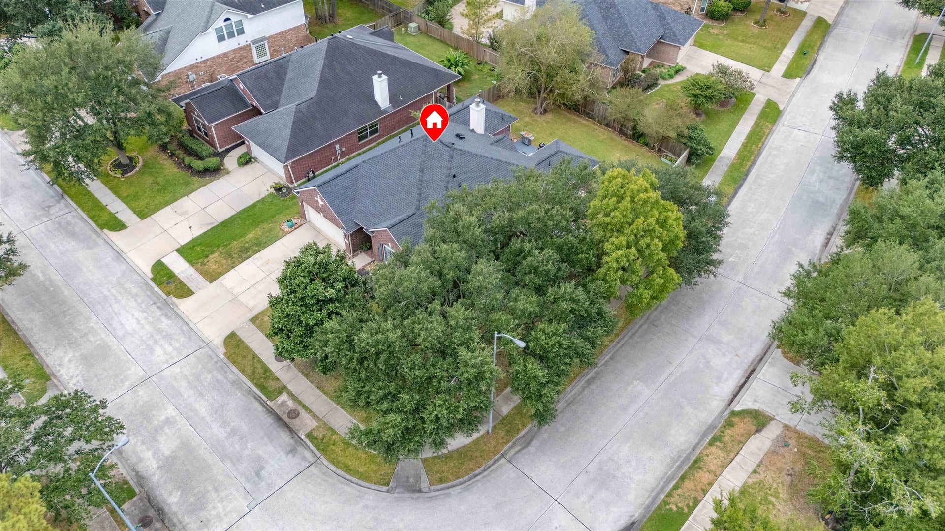 18343 Otter Creek Trail, Humble, TX 77346 Charming corner-lot home nestled among mature trees, offering privacy and ample yard space in a peaceful neighborhood.