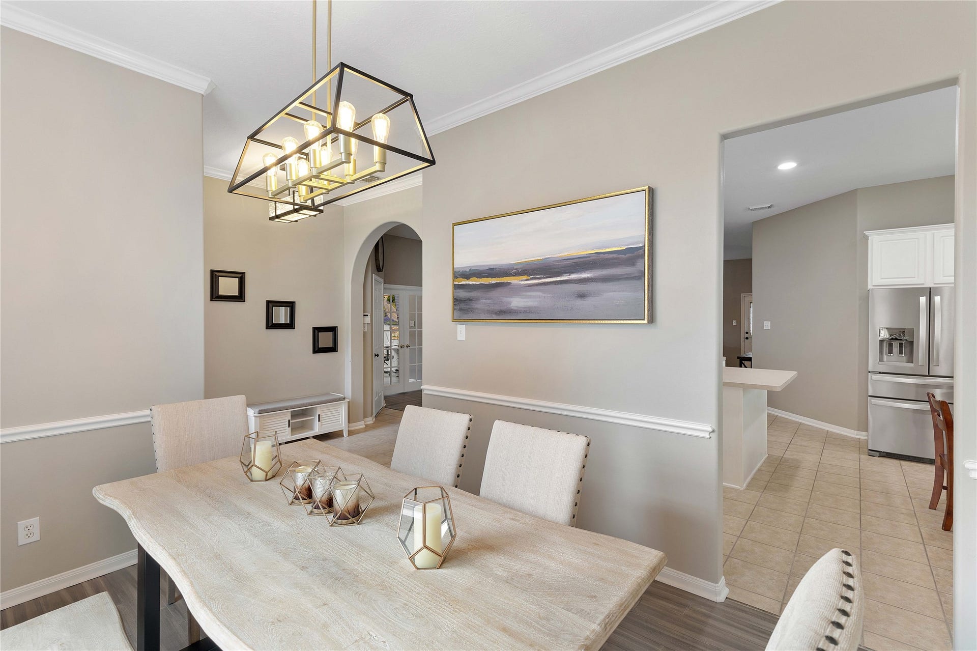 18343 Otter Creek Trail, Humble, TX 77346 Elegant dining area with neutral tones, featuring a modern chandelier and an inviting view into the kitchen.