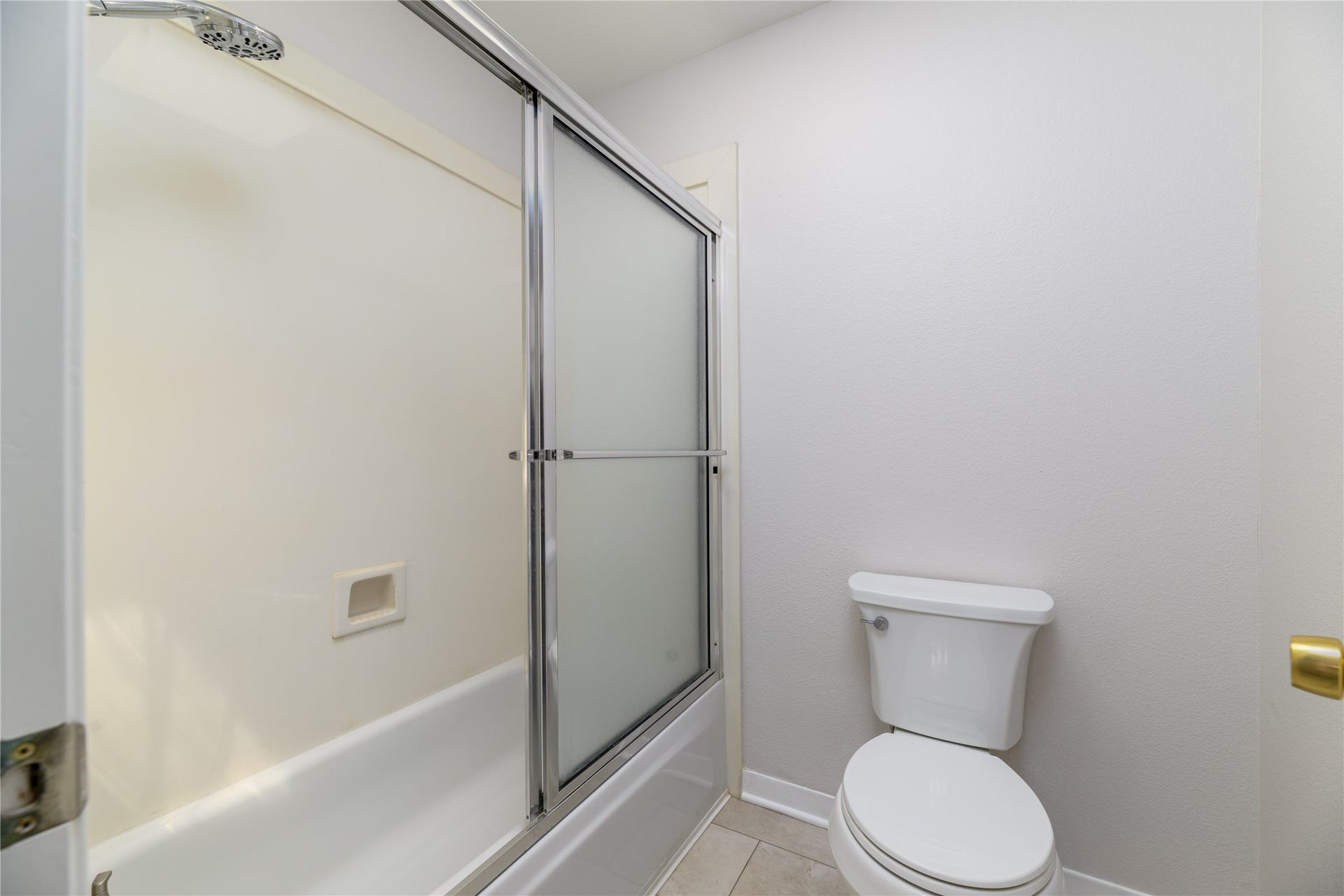 904 Winston Drive, Richmond, TX 77469 Upstairs hall bath has tub/shower combo with sliding glass doors.